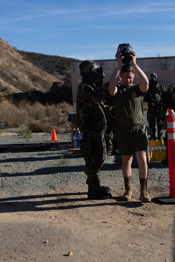 U.S. Marines with the chemical, biological, radiological, and nuclear detachment, Marine Wing Support Squadron 372, Marine Air Control Group 38, 3rd Marine Aircraft Wing, conduct gear and personnel decontamination following the site survey of a simulated abandoned facility during Exercise Steel Knight 23.2 at Marine Corps Air Station Miramar, California, Dec. 14, 2023. Marines conducted a site survey to confirm or deny the presence of CBRN hazards to facilitate the establishment and operation of a forward arming and refueling point. Steel Knight 23.2 is a three-phase exercise designed to train I Marine Expeditionary Force in the planning, deployment and command and control of a joint force against a peer or near-peer adversary combat force and enhance existing live-fire and maneuver capabilities of the MAGTF. (U.S. Marine Corps photo by Lance Cpl. Samantha Devine)