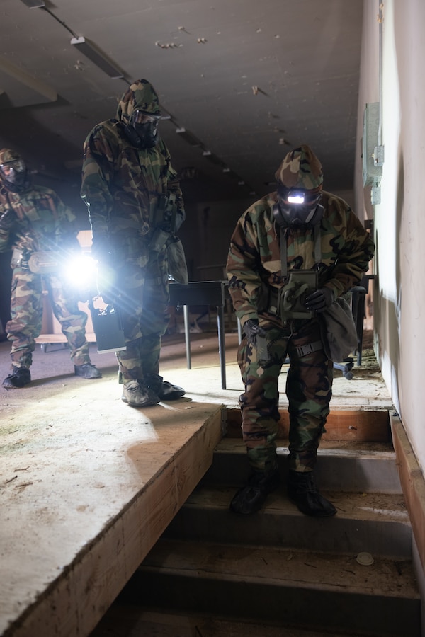 U.S. Marines with the chemical, biological, radiological, and nuclear detachment, Marine Wing Support Squadron 372, Marine Air Control Group 38, 3rd Marine Aircraft Wing, survey a building for simulated potential leaks during Exercise Steel Knight 23.2 at Marine Corps Air Station Miramar, California, Dec. 14, 2023.  Marines surveyed an abandoned facility for the presence of simulated CBRN hazards to facilitate the establishment and operation of a forward arming and refueling point. Steel Knight 23.2 is a three-phase exercise designed to train I Marine Expeditionary Force in the planning, deployment and command and control of a joint force against a peer or near-peer adversary combat force and enhance existing live-fire and maneuver capabilities of the MAGTF. (U.S. Marine Corps photo by Lance Cpl. Samantha Devine)