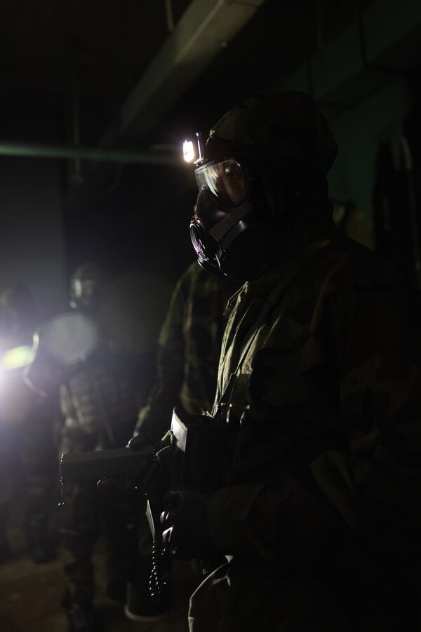 A U.S. Marine with the chemical, biological, radiological, and nuclear detachment, Marine Wing Support Squadron (MWSS) 372, Marine Air Control Group 38, 3rd Marine Aircraft Wing, examines a building for a simulated chemical leak during Exercise Steel Knight 23.2 at Marine Corps Air Station Miramar, California, Dec. 14, 2023. Marines surveyed an abandoned facility for the presence of simulated CBRN hazards to facilitate the establishment and operation of a forward arming and refueling point. Steel Knight 23.2 is a three-phase exercise designed to train I Marine Expeditionary Force in the planning, deployment and command and control of a joint force against a peer or near-peer adversary combat force and enhance existing live-fire and maneuver capabilities of the MAGTF. (U.S. Marine Corps photo by Lance Cpl. Samantha Devine)