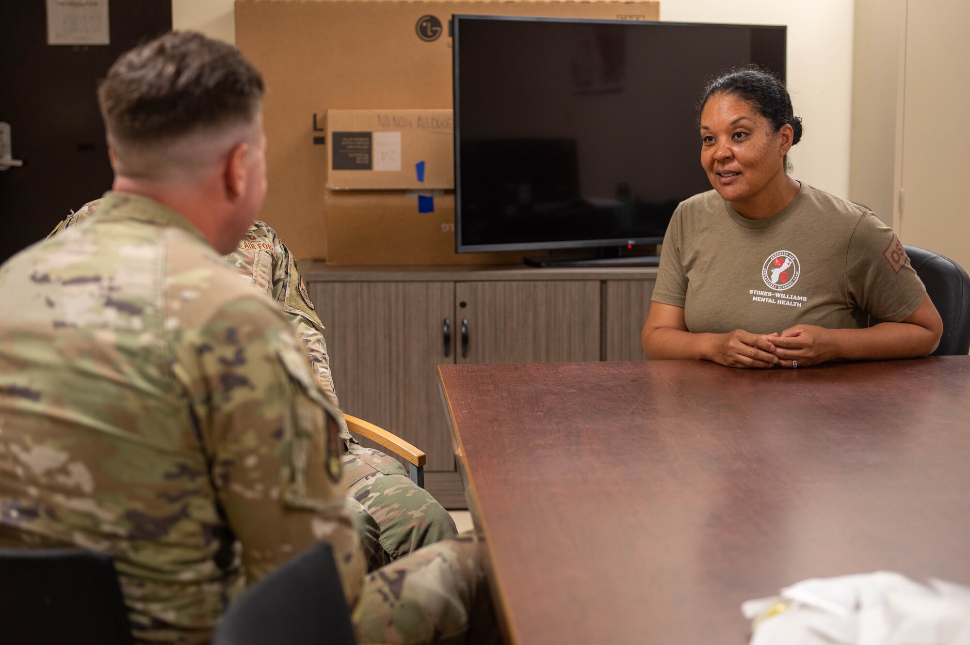 U.S. Air Force Maj. Charu Stokes-Williams (right), 36th Medical Group mental health flight commander, speaks with members assigned to the 36th Munitions Squadron at Andersen Air Force Base, Guam, Nov. 3, 2023. The Operational Support Team is a medical team of active duty and civilian personnel that consist of a physical therapist, a psychologist, a social worker, a strength and conditioning specialist and a team specialist that get attached to units for a period of time to improve mental and physical health. (U.S. Air Force photo by Airman 1st Class Allon Lapaix)