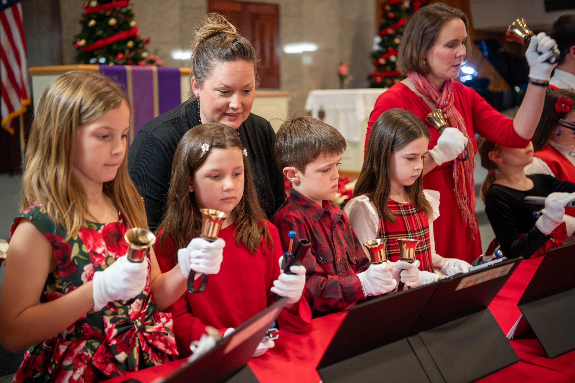 Members of a handbell choir perform during a holiday cantata in the main chapel at Yokota Air Base, Japan.