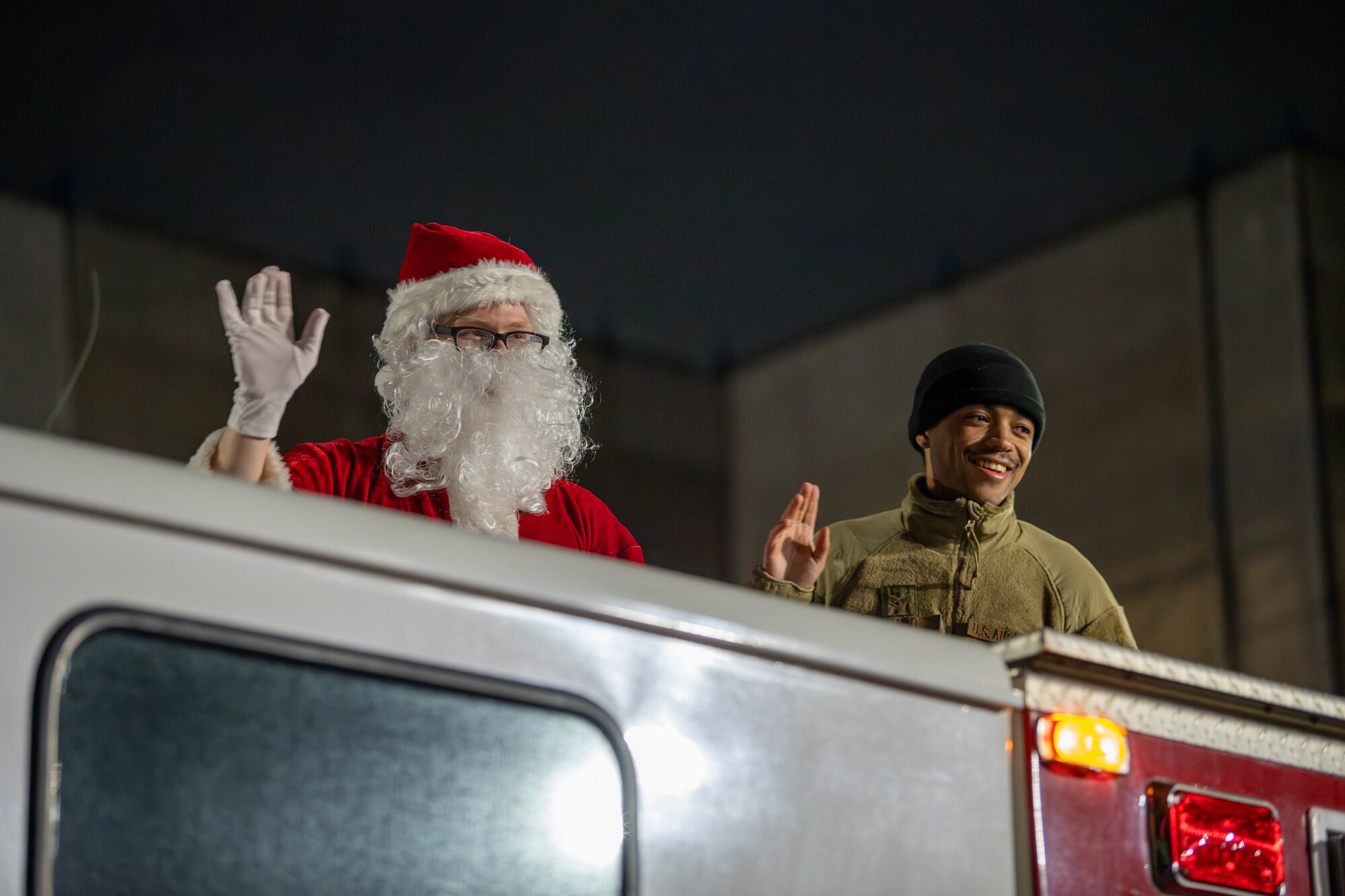 Santa Claus waves to families from a fire truck following a tree lighting ceremony at the main chapel on Yokota Air Base, Japan.