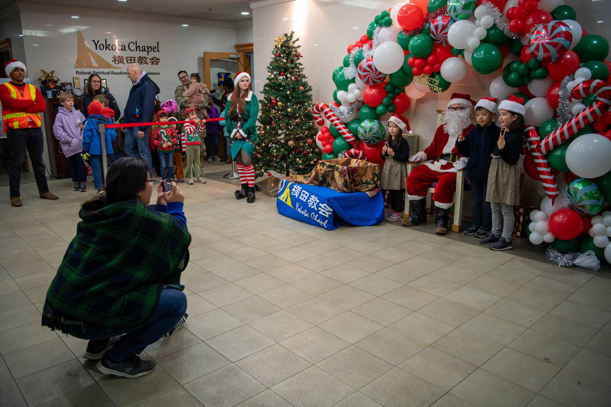 Children take a picture with Santa Claus during a meet-and-greet at the main chapel on Yokota Air Base, Japan.