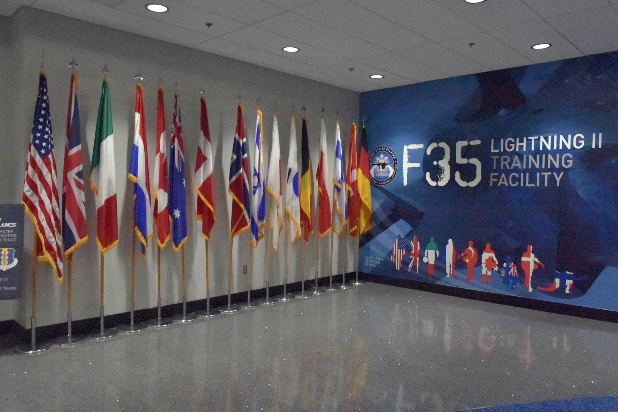 Flags are displayed along a wall at the F-35 schoolhouse on Eglin AFB, Florida.