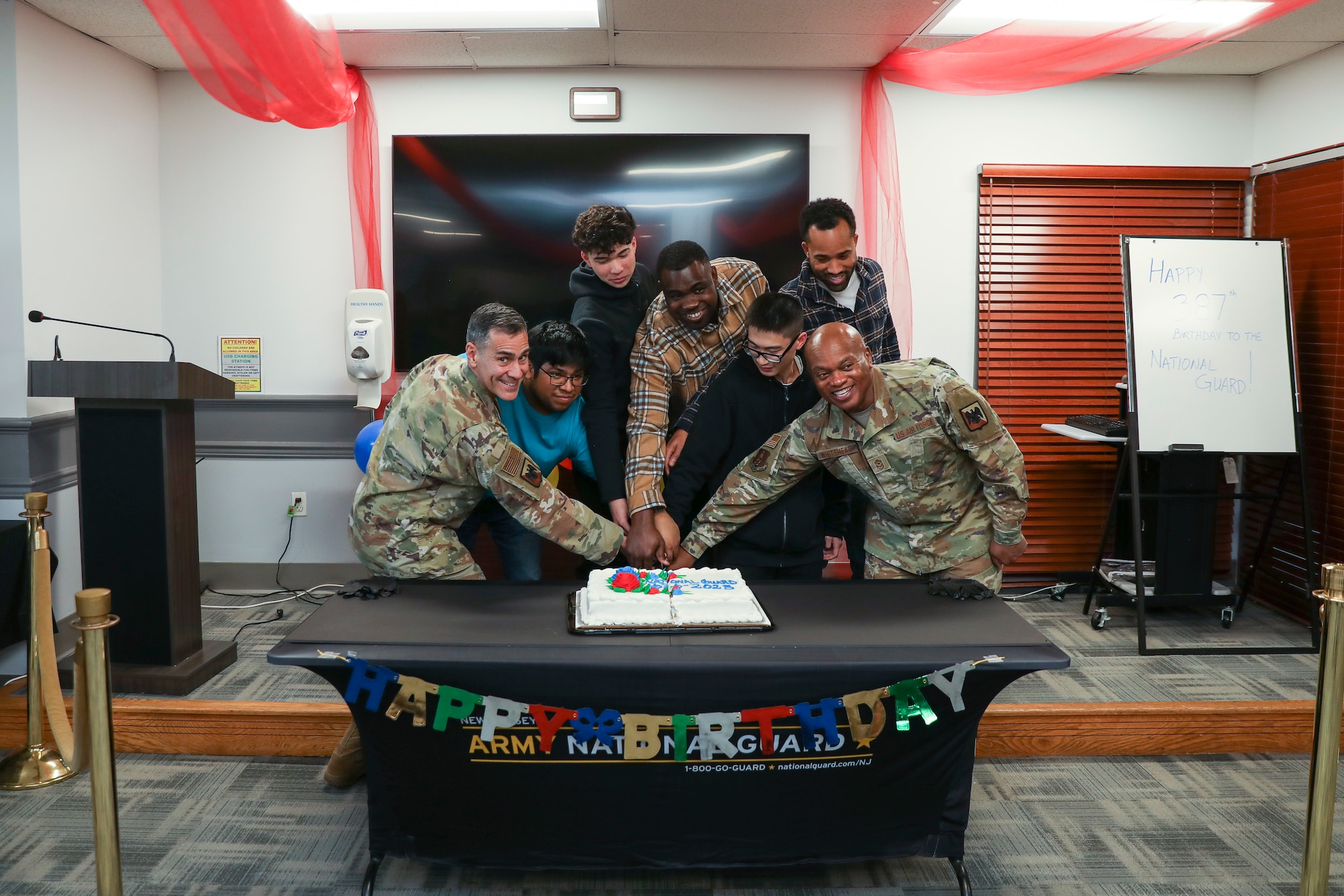 Air Force Lt. Gen. Marc Sasseville, vice chief of the National Guard Bureau, and Senior Enlisted Advisor Tony Whitehead, SEA to the chief of the National Guard Bureau, cut a cake to mark the Guard’s 387th birthday with the newest New York National Guard enlistees at the Fort Hamilton Military Enlistment Processing Station, Brooklyn, New York, Dec. 13, 2023. The National Guard was officially founded on Dec. 13, 1636, when the Massachusetts Colony established the first militia regiments.