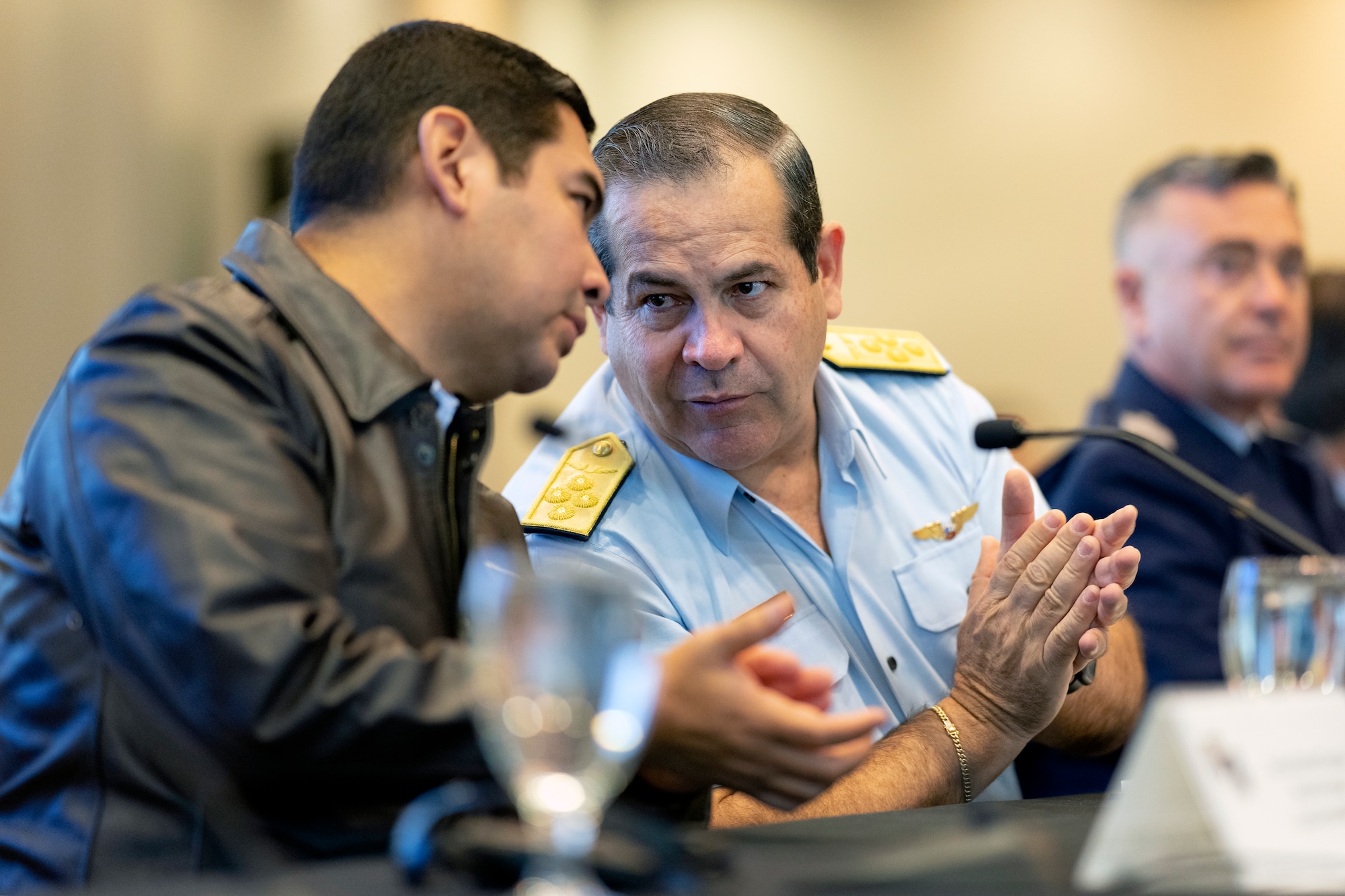 Lt. Gen. Carlos Enrique Chávez Cateriano, Peruvian air chief, right, speaks with Col. Manfred Rondón, Peru Liaison Officer, left, during the South American Air Chiefs Conference in Tucson, Ariz. Dec. 6, 2023.