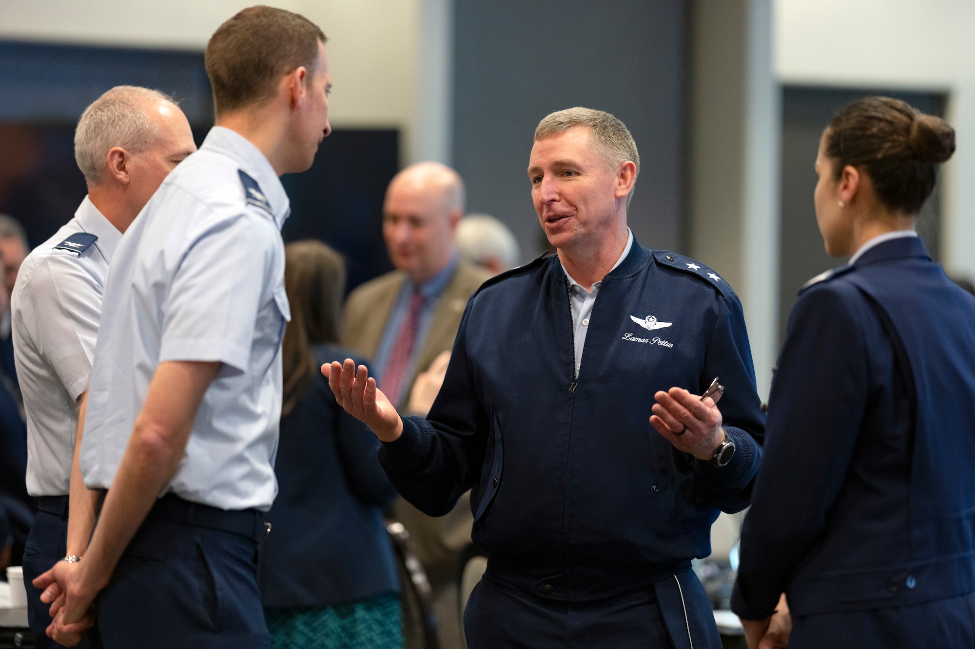 U.S. Air Force Maj. Gen. Evan Pettus, 12th Air Force (Air Forces Southern) commander, center, speaks with USAF and Peruvian air force delegates during the South American Air Chiefs Conference in Tucson, Ariz. Dec. 6, 2023.