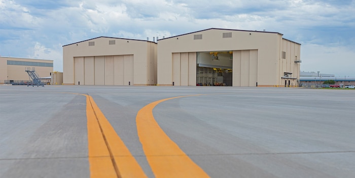 photo of the hangar with aircraft leading lines headed to the two-bay building