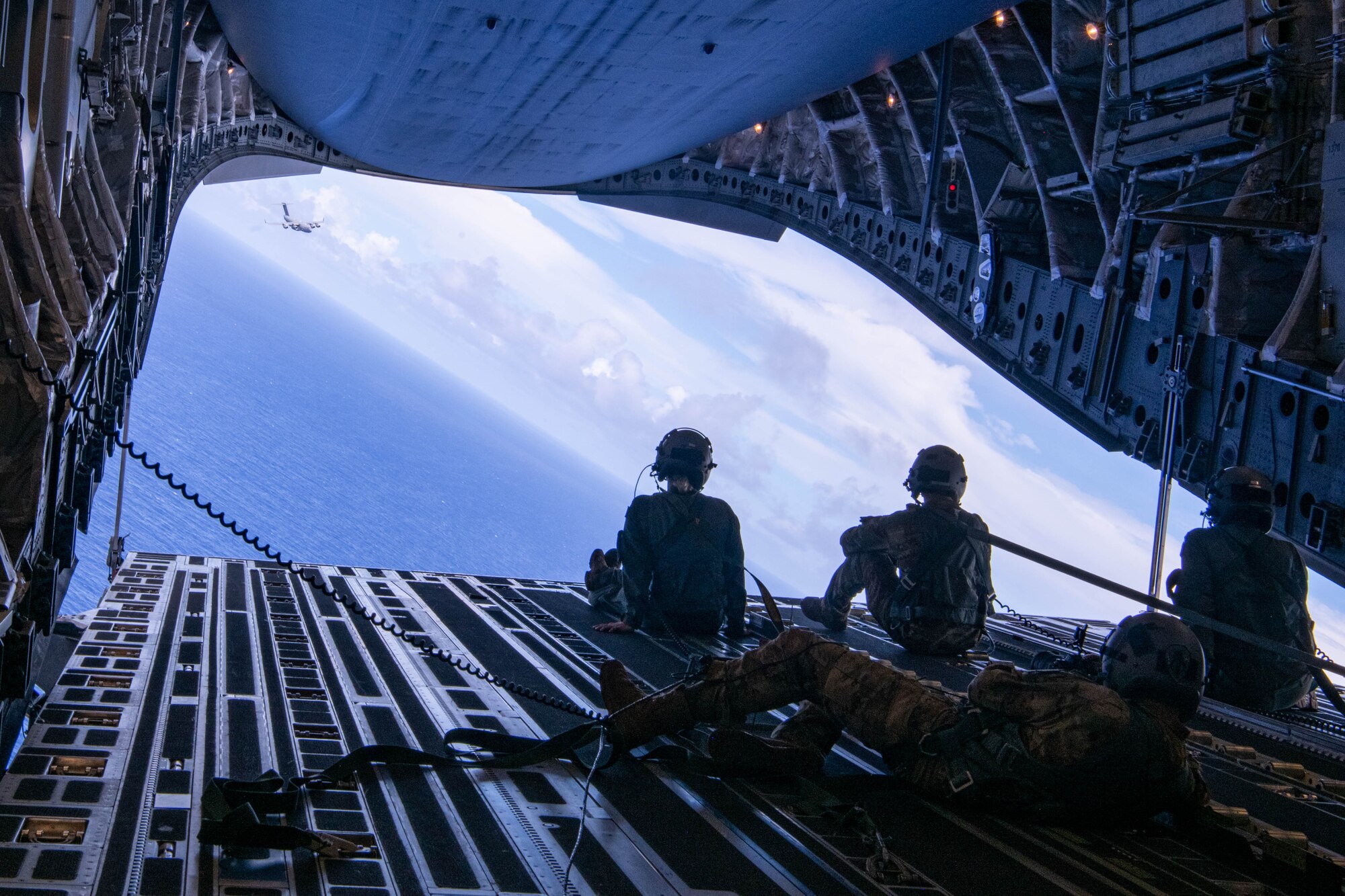 Coalition loadmasters look out over the Pacific Ocean from an Australian C-17 during a Joint airdrop
near Andersen Air Force Base, Guam on July 12, 2023. This airdrop was part of Mobility Guardian 23
and showed how Allies and partners are capable of resupplying remote areas. MG23 is a mobility
exercise held across a 3,000-mile area intended to deepen interoperability with U.S. Allies and
partners, bolstering the collective ability to support a free and open Indo-Pacific area. (U.S. Air Force
photo by A1C Caleb Parker)
