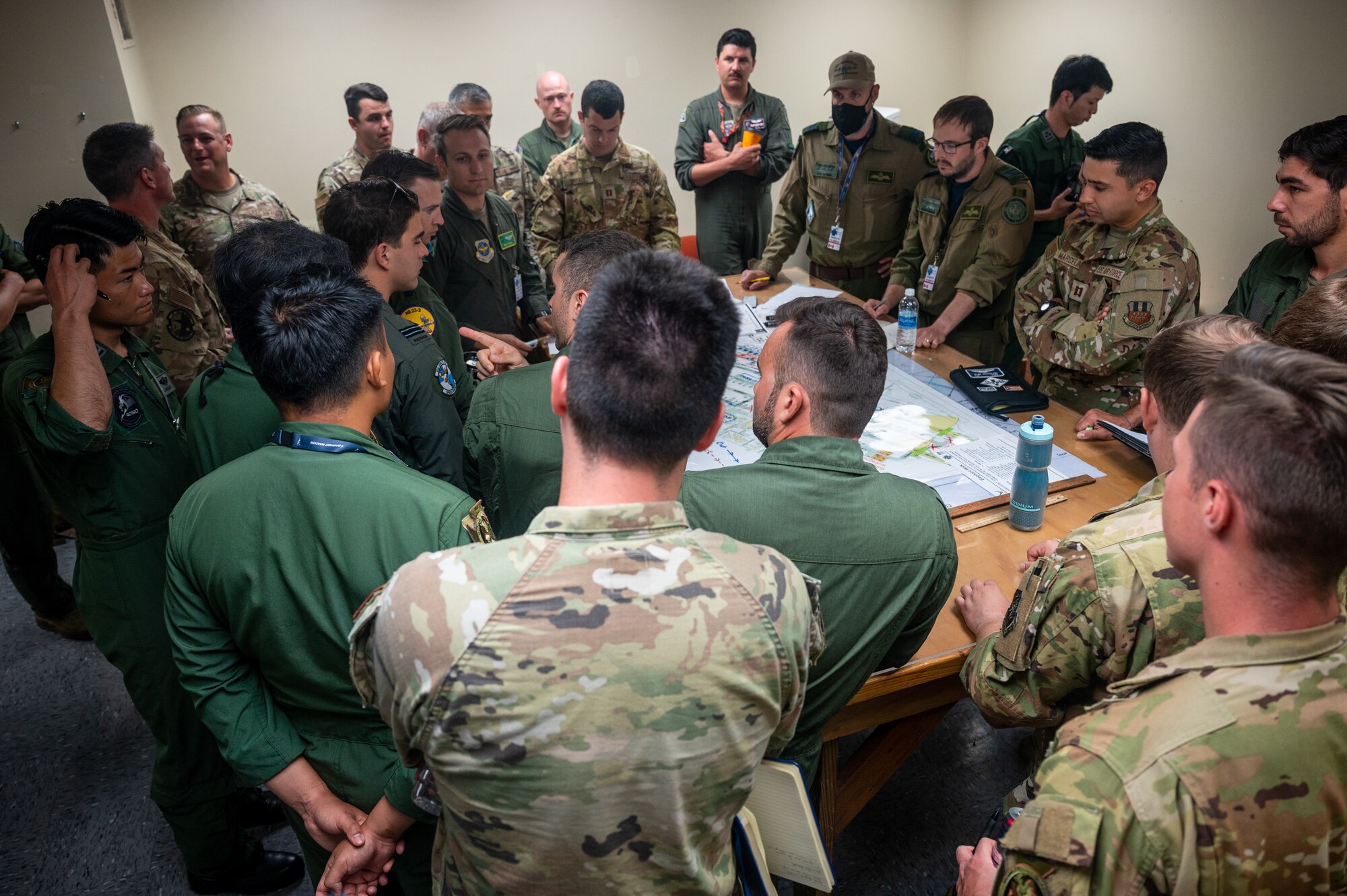 Members from multiple nations air forces gather together to plan an elephant walk during Mobility Guardian 23 in Andersen Air Force Base, Guam, July 18, 2023. MG23 is an opportunity to train alongside our Allies and partners to demonstrate interoperability and bolster our collective ability to support a free and open Indo-Pacific. (U.S. Air Force photo by Tech. Sgt. Sean Carnes)