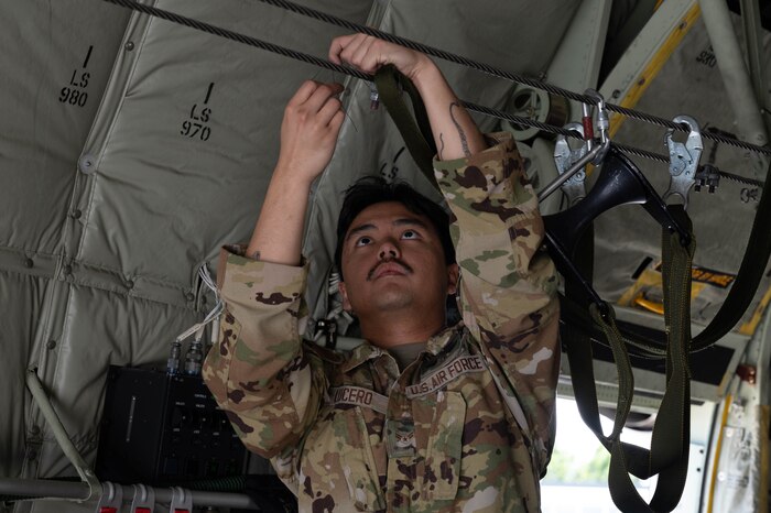 A USAF Loadmaster prepares a C-130J Super Hercules for static-line jumps.