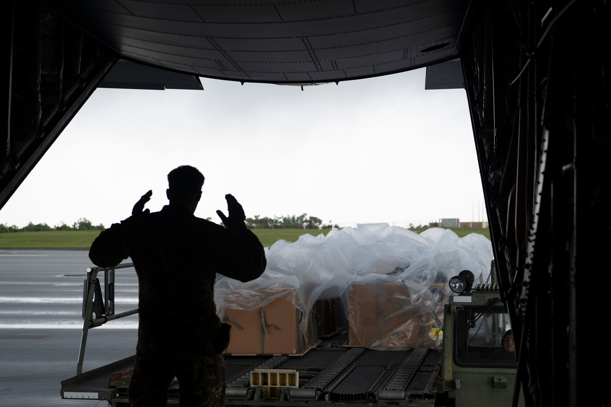 U.S. Air Force Senior Master Sgt. Kevin Cruz, 36th Airlift Squadron senior enlisted leader, Yokota Air Base, Japan, is loading supply bundles on to a C-130J Super Hercules during Operation Christmas Drop at Andersen Air Force Base, Guam, Dec. 3, 2023.