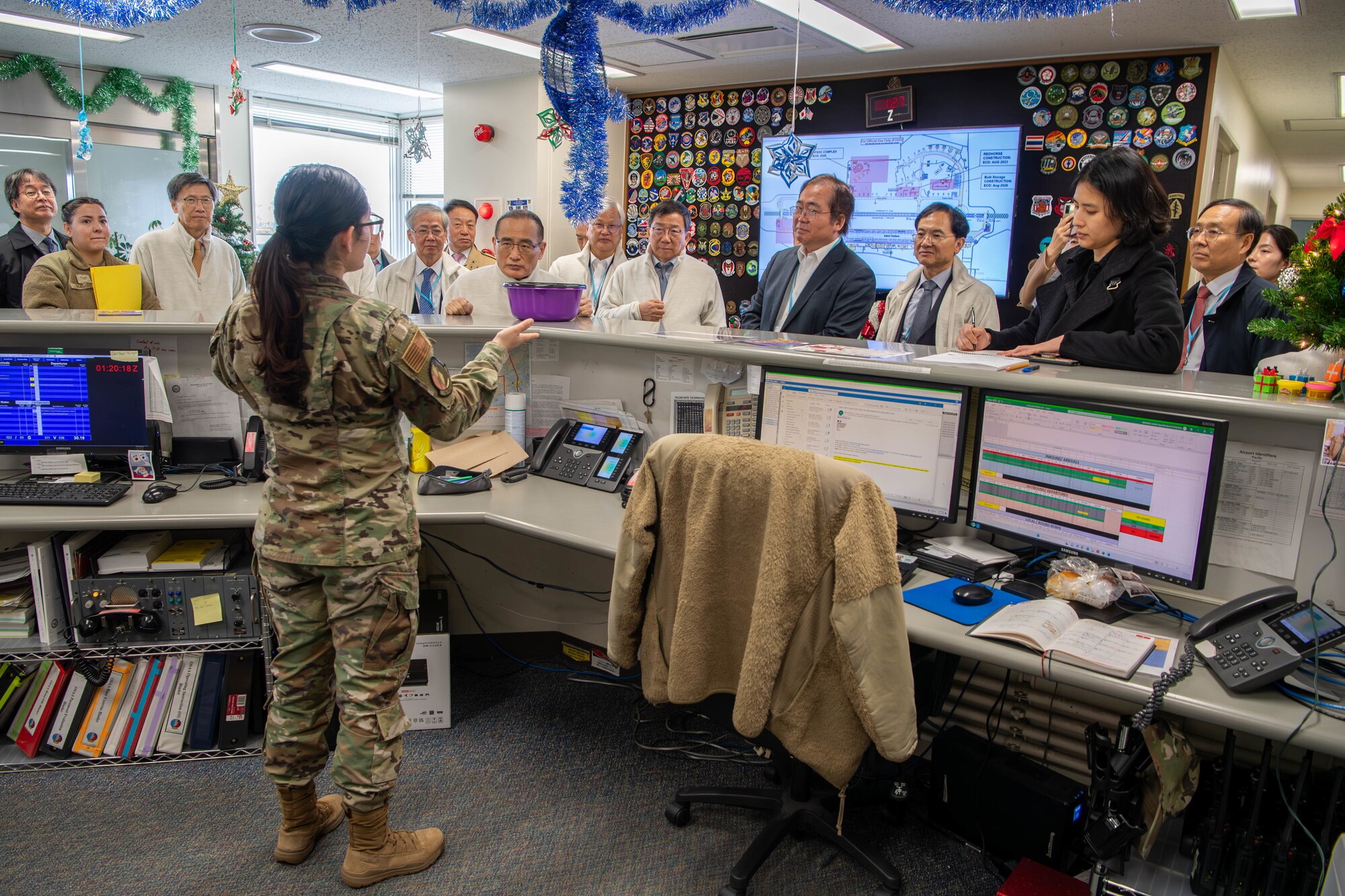 Members of the Korea Peace Foundation receive a briefing at the 374th Operations Group on Yokota Air Base, Japan.
