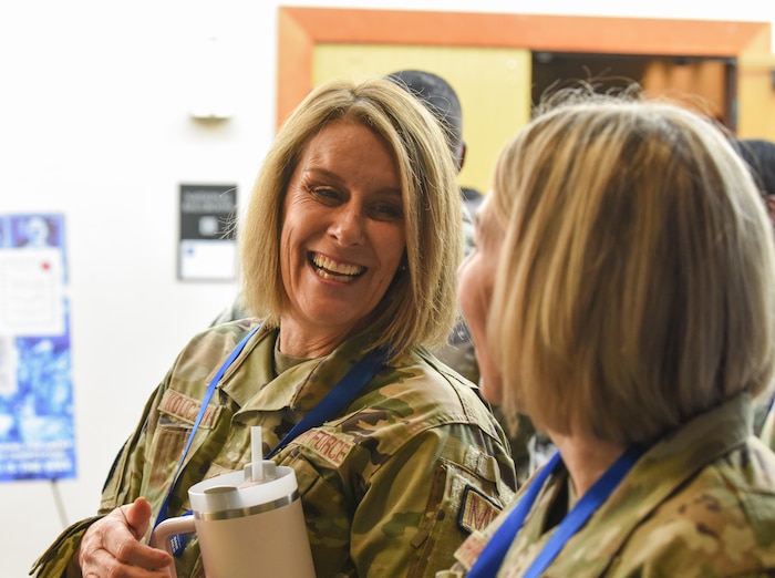 Image of an Airman smiling at another Airman.