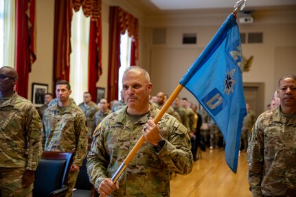 U.S. Army Brig. Gen. Leland Blanchard II presents the guidon as the District of Columbia Army National Guard officially activates Delta Company, 223rd Military Intelligence Battalion during a ceremony Dec. 9, 2023, at the D.C. Armory in Washington, D.C. The unit is the first of its kind in the D.C. Army National Guard.  (U.S. Army National Guard photo by Sgt. 1st Class Erica Jaros)