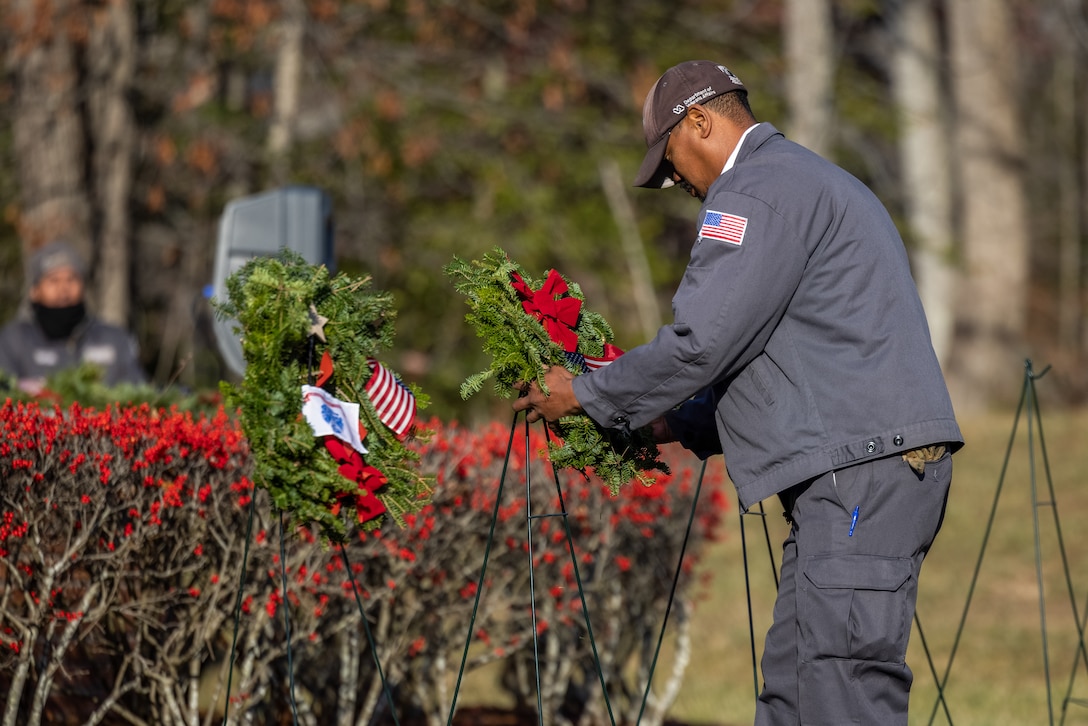 Jared Bennett, native of Fayetteville, North Carolina, and maintenance worker for the cemetery, lays a wreath for the Marine Corps during the annual Wreaths Across America wreath-laying ceremony at the National Cemetery at Quantico, Triangle, Virginia, Dec. 16, 2023. The event was held in unity with other cemeteries nationwide to remember and honor those who paid the ultimate sacrifice, but also to teach generations about those who have and currently serve. (U.S. Marine Corps photo by Lance Cpl. Ethan Miller)