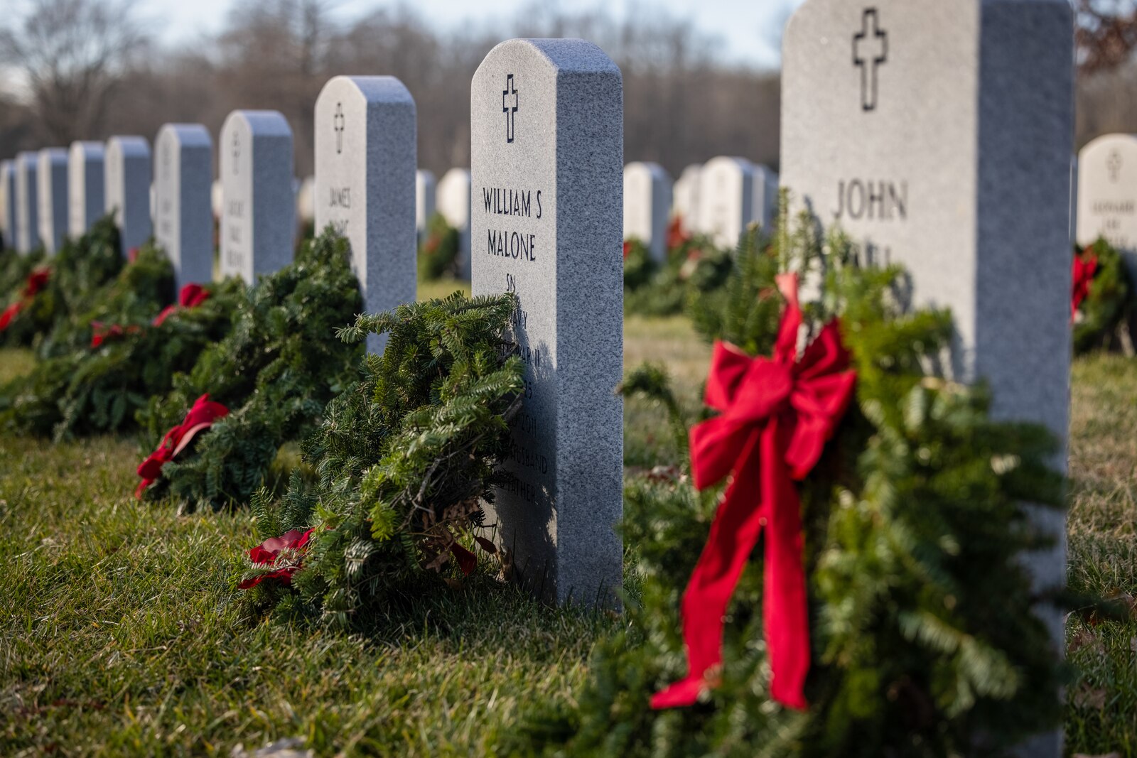 U.S. servicemembers and family members honor the fallen during the annual Wreaths Across America wreath-laying ceremony at the National Cemetery at Quantico, Triangle, Virginia, Dec. 16, 2023. The event was held in unity with other cemeteries nationwide to remember and honor those who paid the ultimate sacrifice, but also to teach generations about those who have and currently serve. (U.S. Marine Corps photo by Lance Cpl. Ethan Miller)