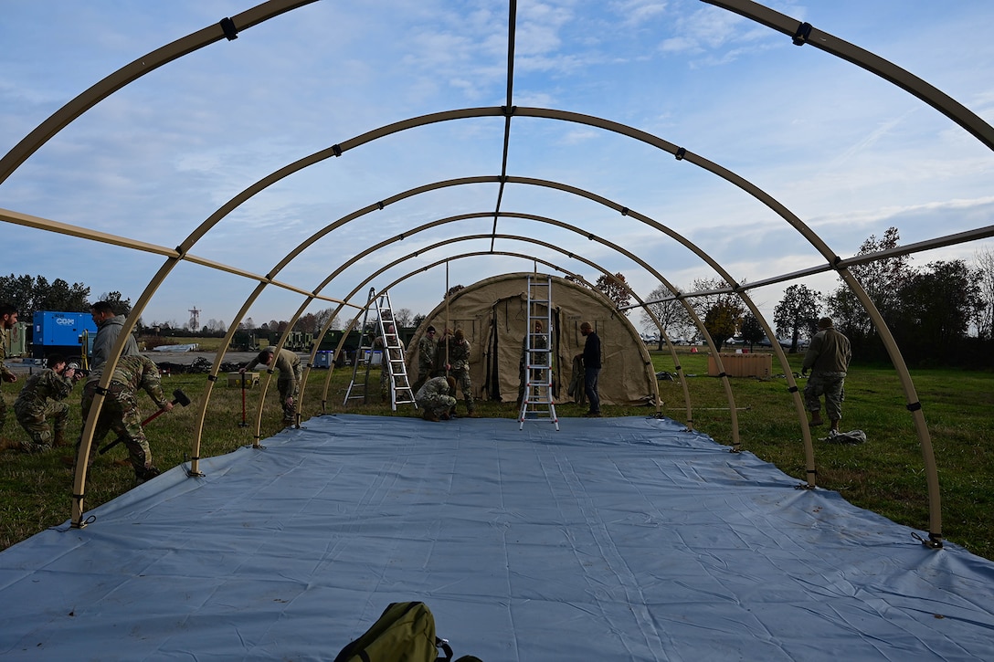 Airmen set up a tent for a training exercise.