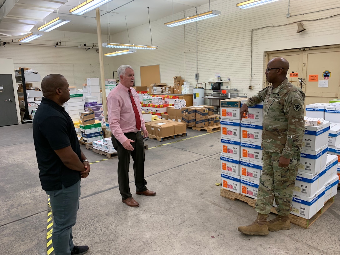 Men conversate in a warehouse