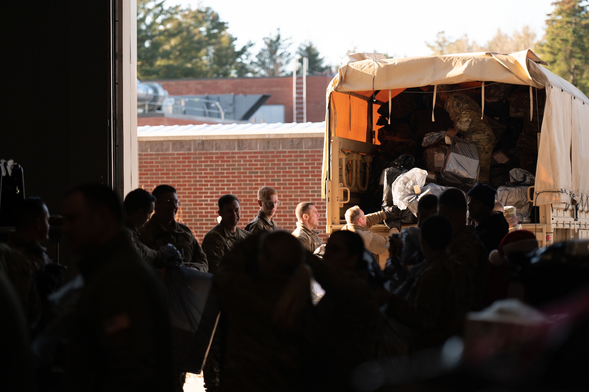 Guardsmen load gifts into Humvee