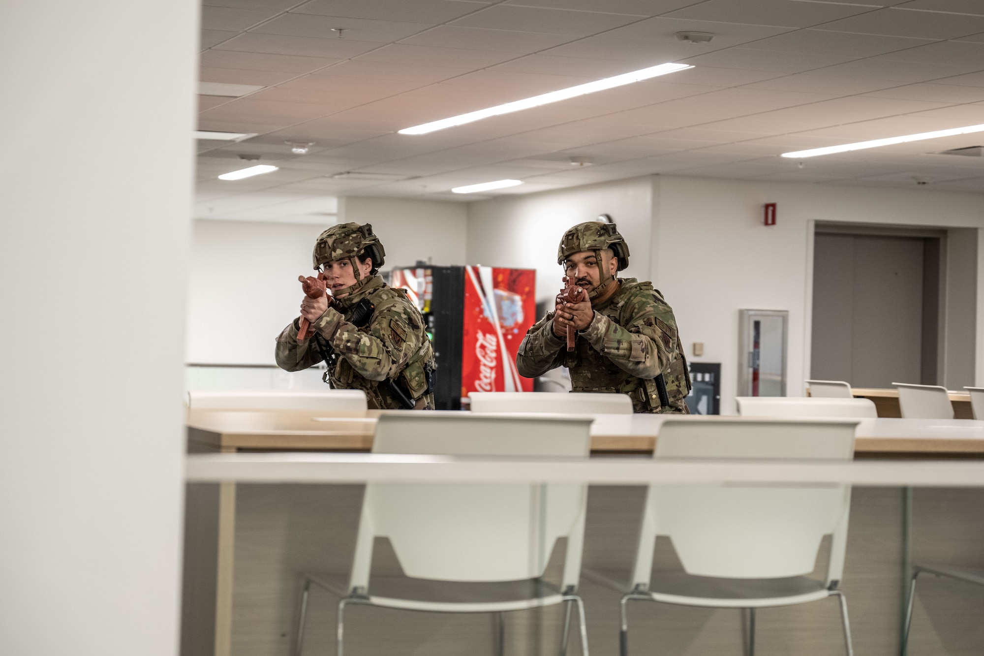 Security Forces airmen walk through building.