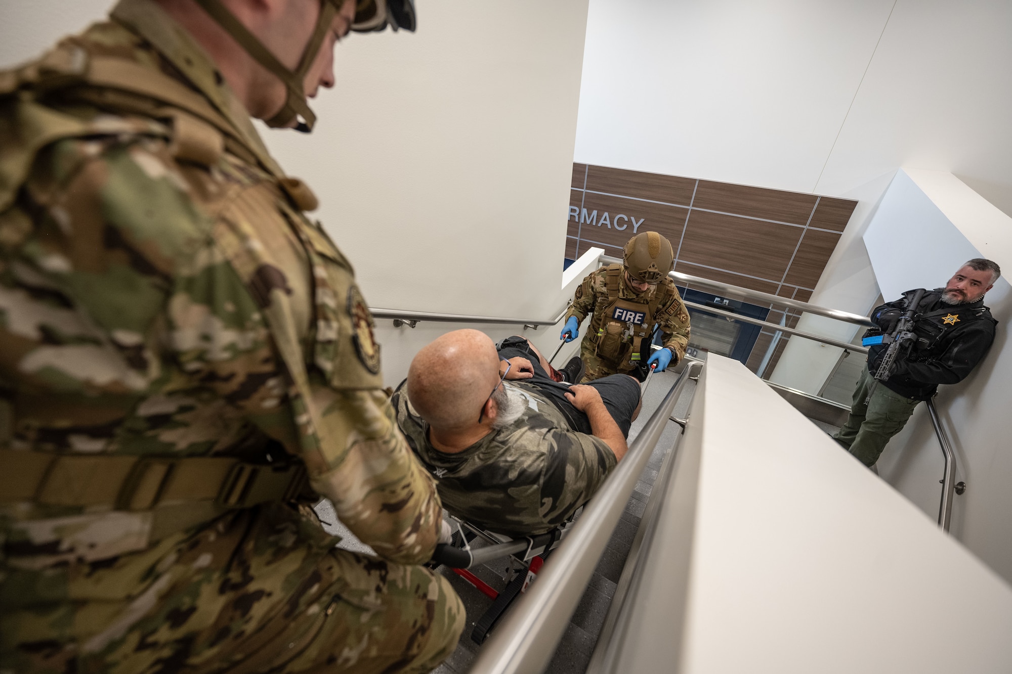 Man is carried down flight of stairs.