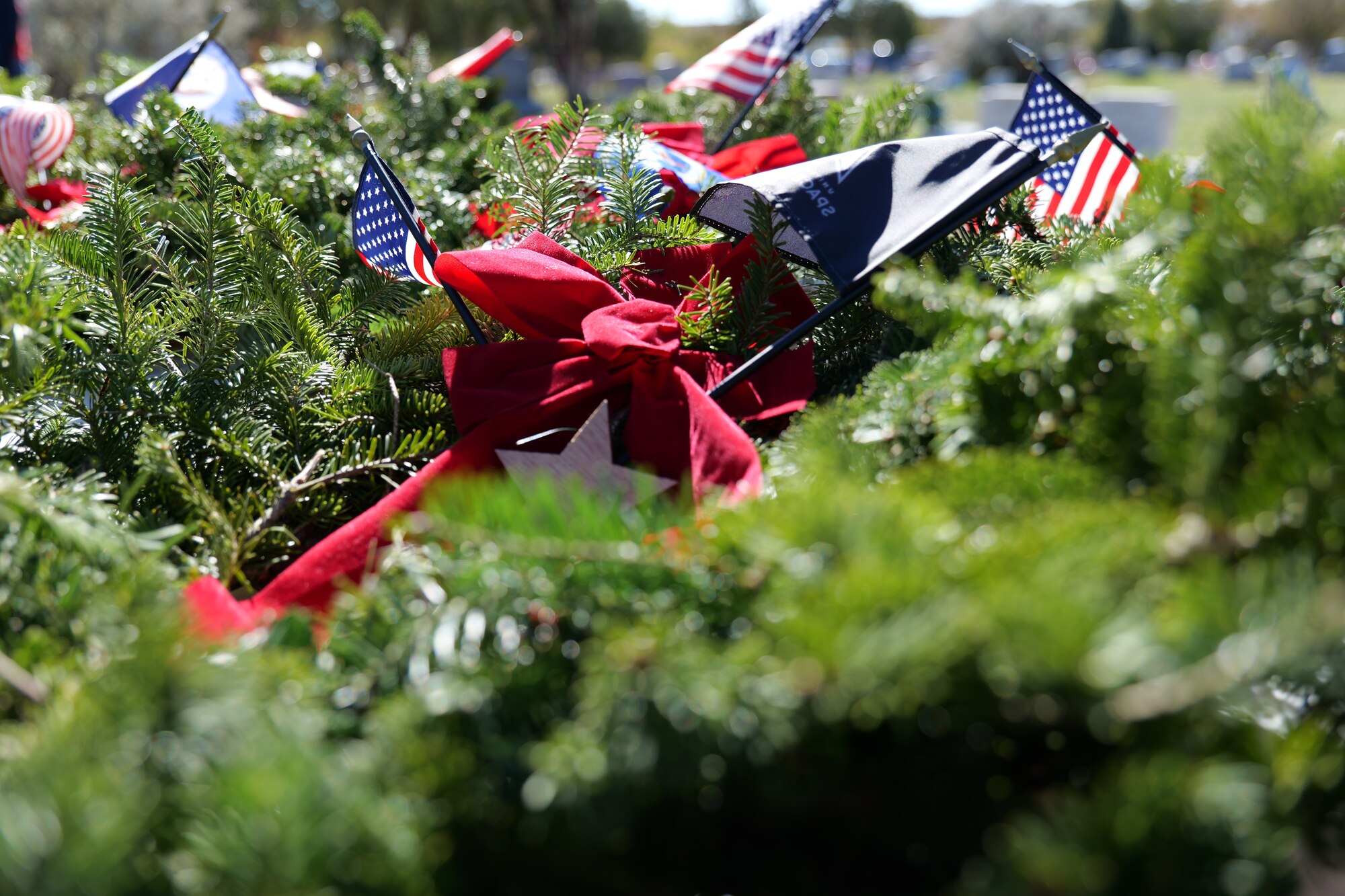 Wreaths for the Wreaths Across America Ceremony at Belvedere Memorial Park Cemetery rest on a table in San Angelo, Texas, Dec. 16, 2023. Leadership from Goodfellow Air Force Base and community members from San Angelo came together to honor all military members, past and present. (U.S. Air Force photo by Staff Sgt. Nathan Call)