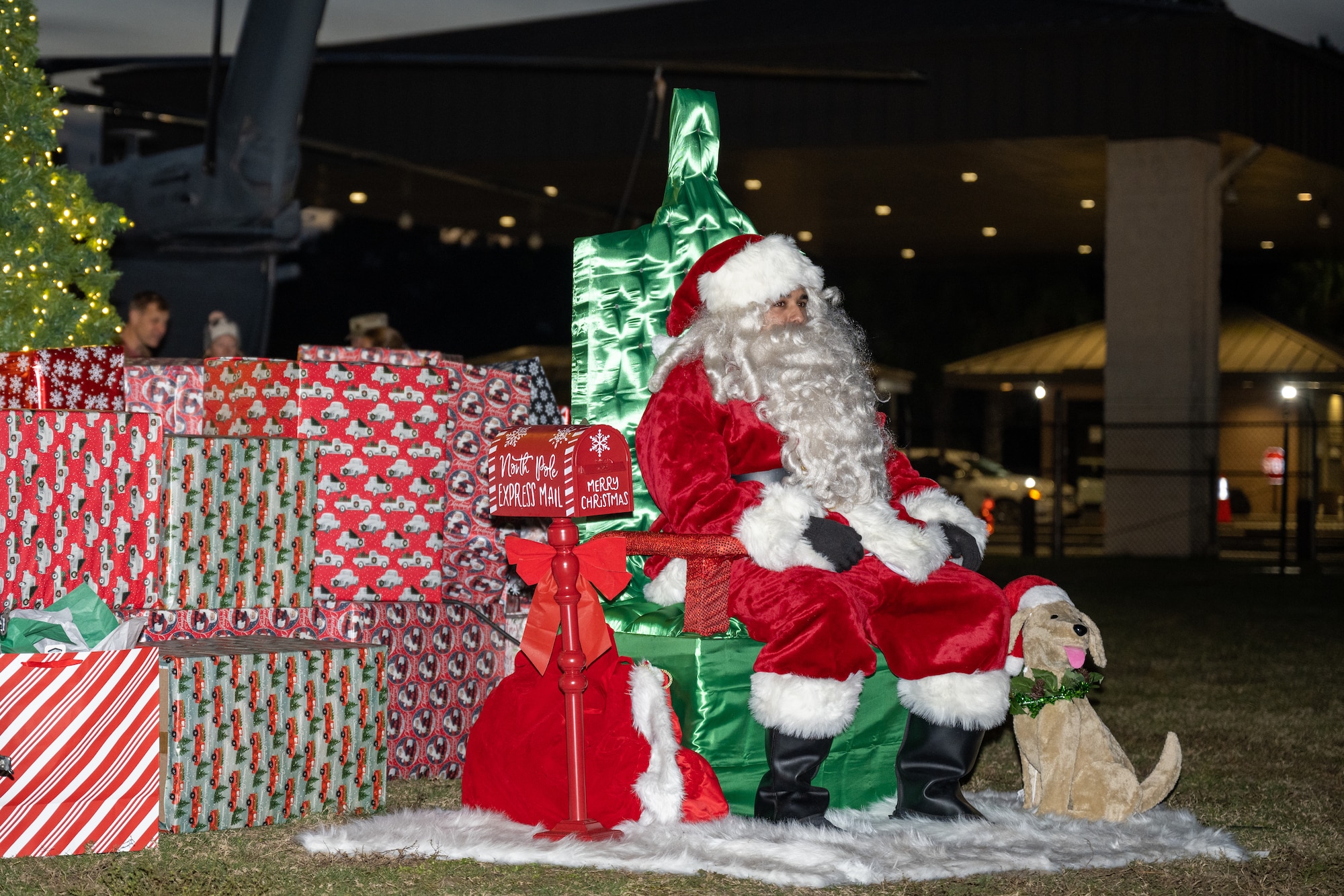 Santa Claus visits with children during the Christmas tree lighting ceremony at Hurlburt Field, Florida, Dec. 7, 2023. Air Commandos and families celebrated the holiday season by attending a winter wonderland event and the Christmas tree lighting ceremony. (U.S. Air Force photo by Senior Airman Alysa Calvarese)