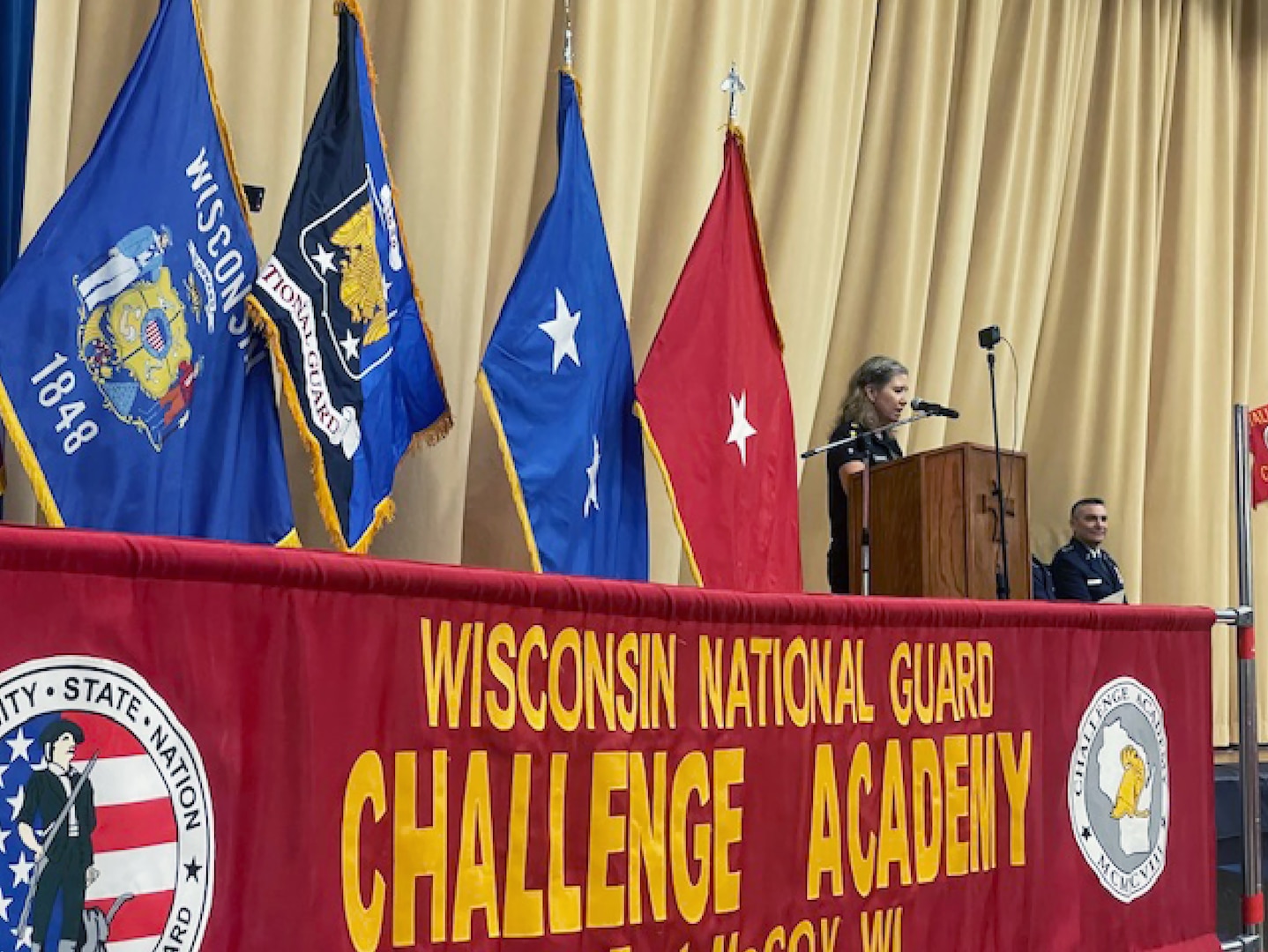 Wisconsin Challenge Academy Director Joni Mathews addresses 98 cadets from 33 Wisconsin counties during a graduation ceremony Dec. 16 at Baraboo High School in Baraboo, Wis. Challenge Academy reshapes the lives of 16-to-18-year-olds at risk of not graduating from high school. It uses a structured, military-style environment and state-certified teachers and counselors to build Cadets’ academic abilities, character, self-confidence, and personal discipline. Wisconsin Department of Military Affairs photo by Thomas Beckman