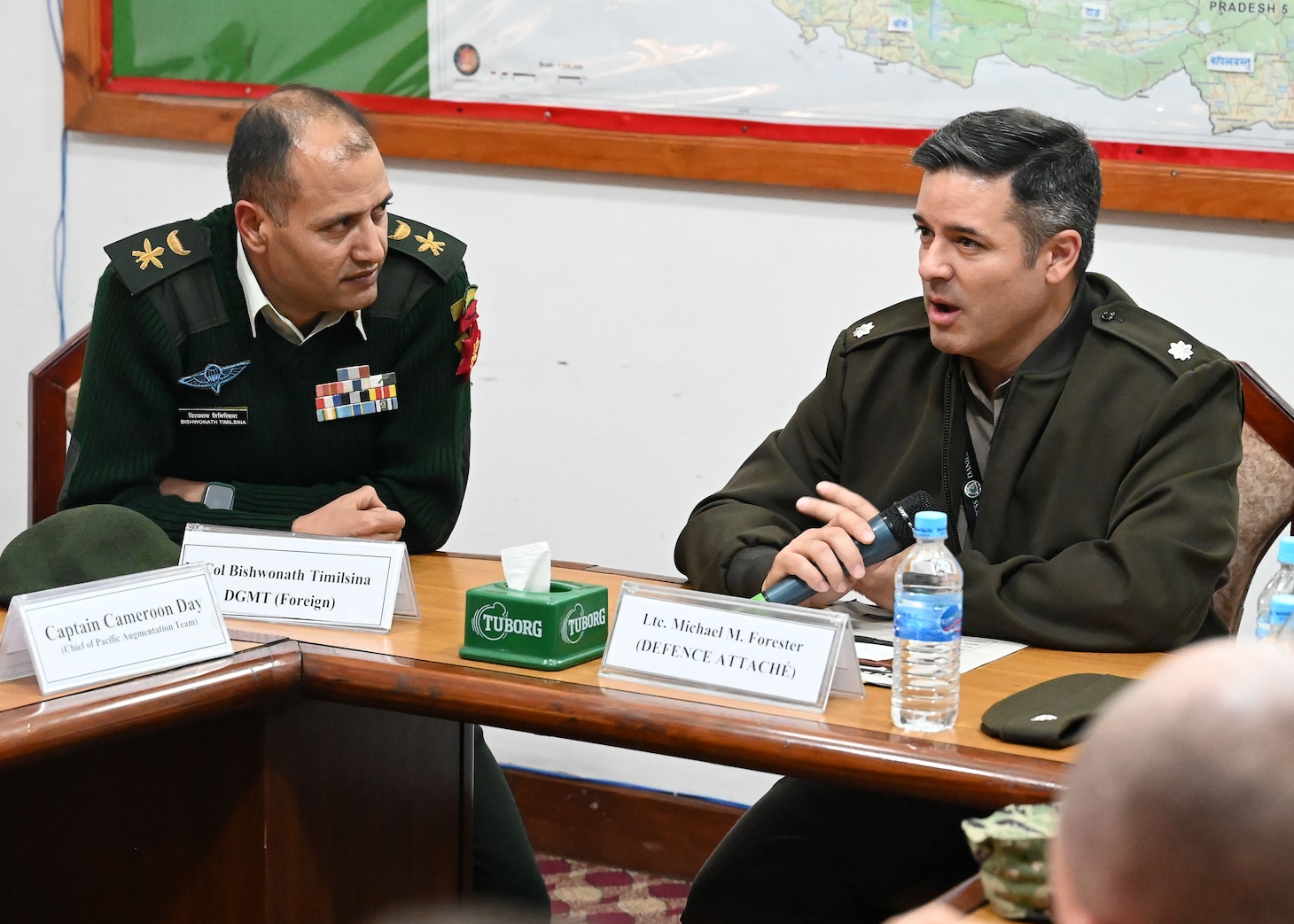 U.S. Army Lt. Col. Micheal M. Forester, right, U.S. Defense Attaché to Nepal, and Lt. Col. Bishwonath Timilsina, Director General of Military Training (Foreign), Nepali Army, speak during the closing remarks of a U.S. and Nepal subject matter expert exchange at Ganesh Kashya, the Nepali Army headquarters in Kathmandu, Nepal. Naval Special Warfare trains with forces worldwide to improve and further specialize skills required to conduct missions and respond to crises.