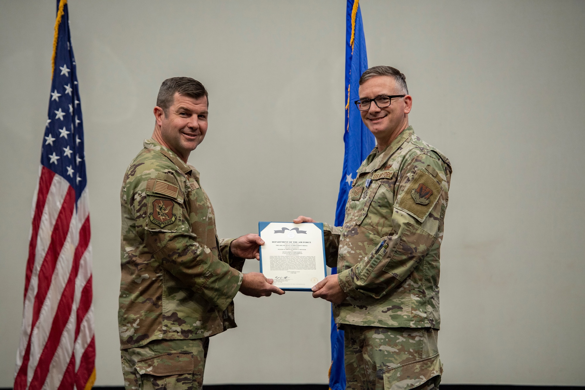 Base commander poses for photo with award recipient