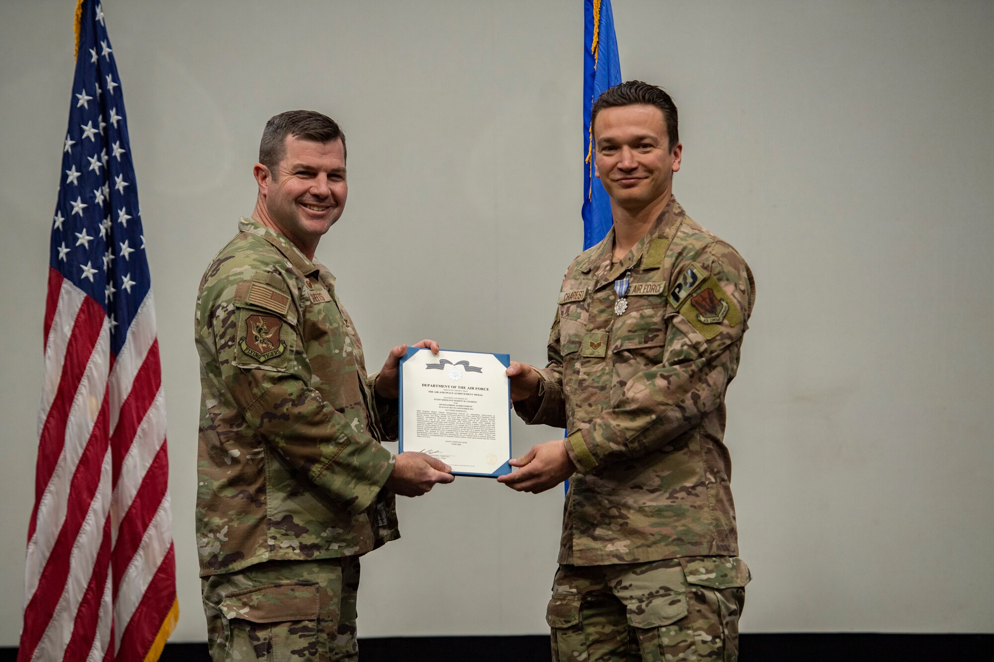 Base commander poses for photo with award recipient