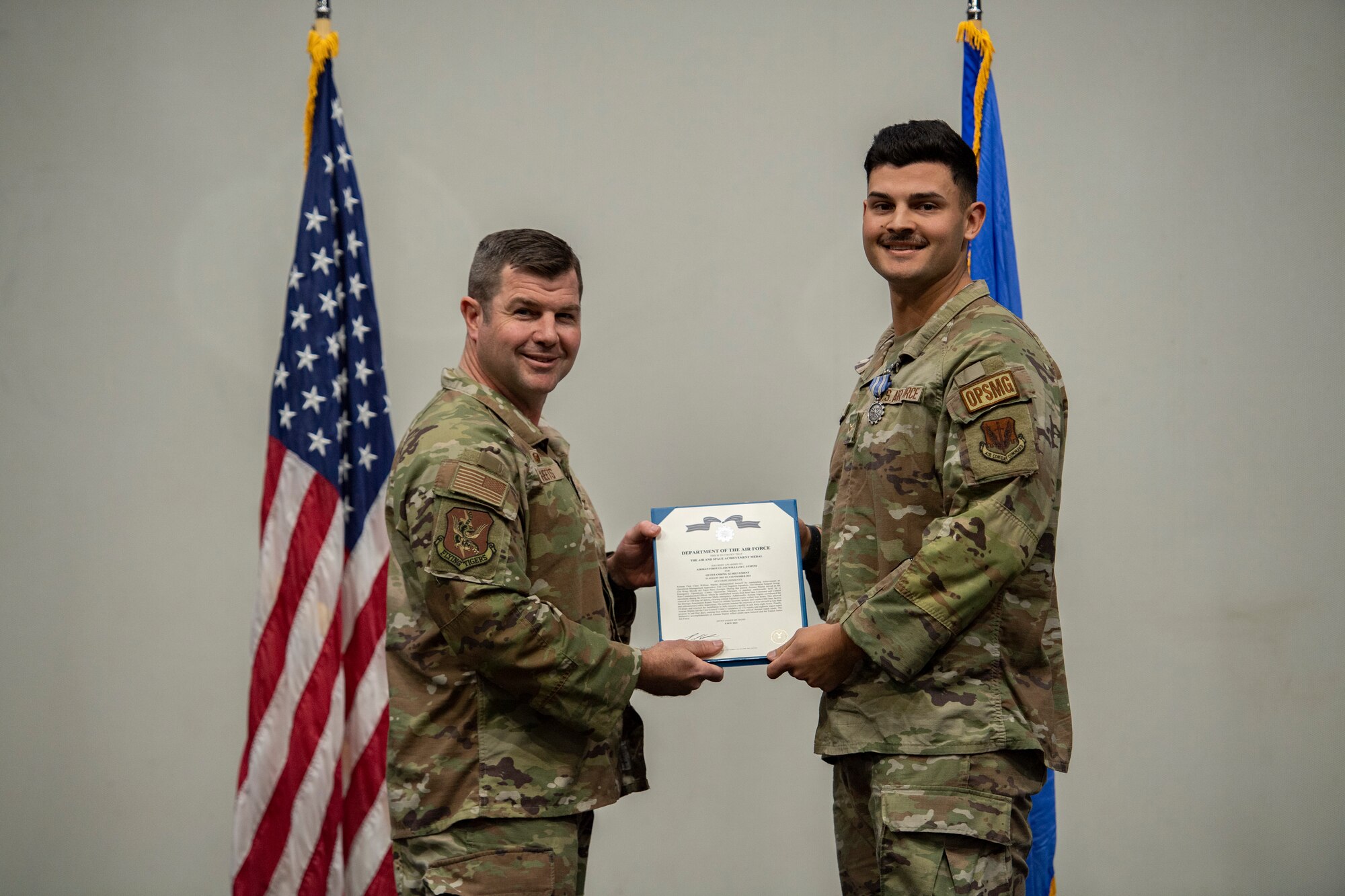 Base commander poses for photo with award recipient