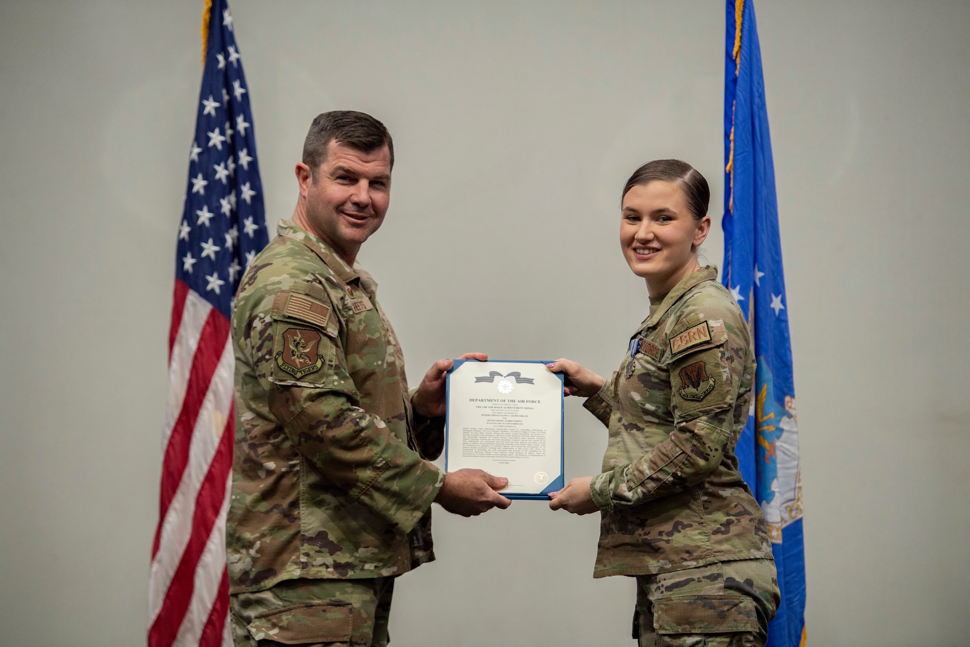 Base commander stands with bronze star recipient for photo