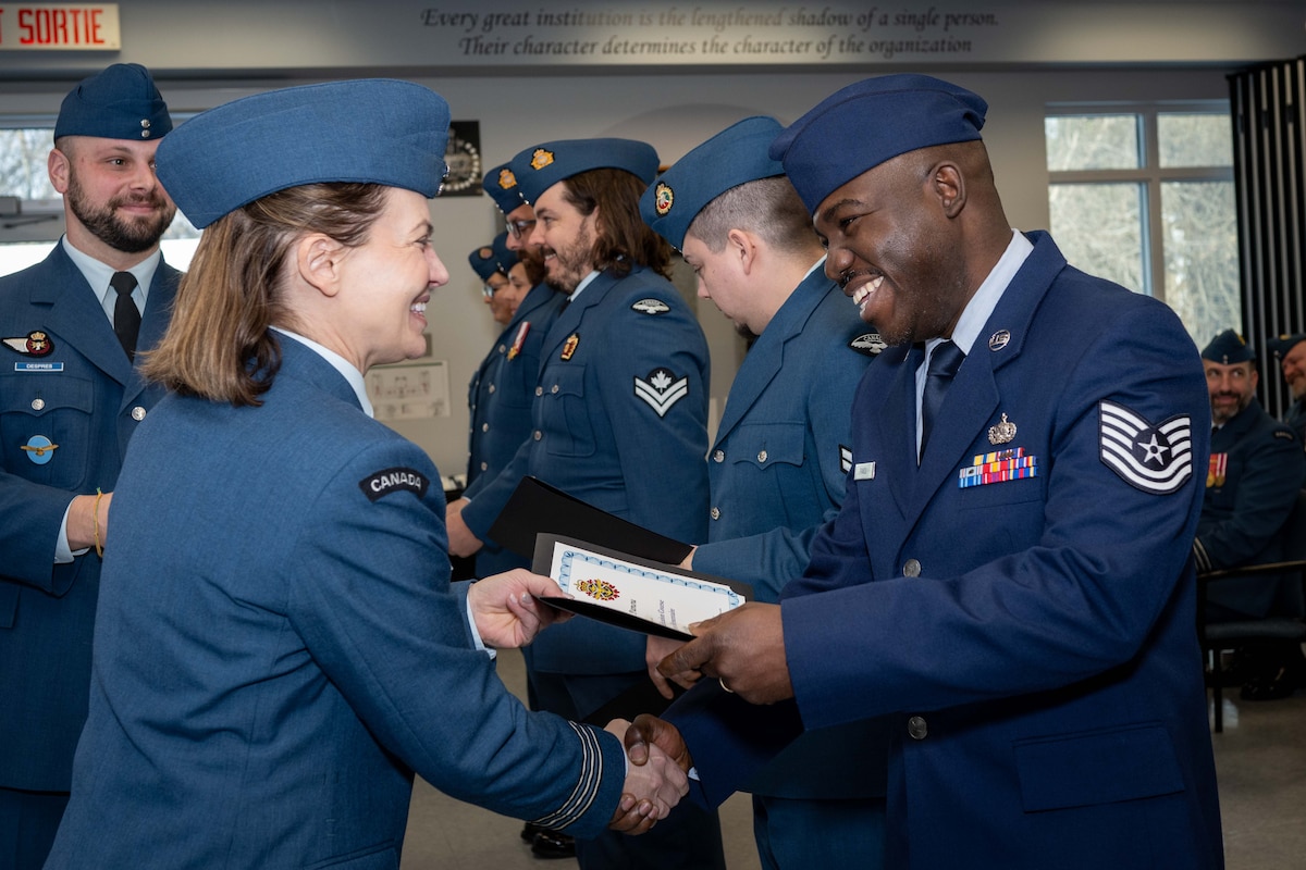 Canadian Armed Forces and United States Air Force students of the Primary Leadership Qualification Course 2305 come together for a graduation on December 13, 2023, at 16 Wing/Canadian Forces Base Borden, Ontario, to receive their Military Certificates of Achievement.
