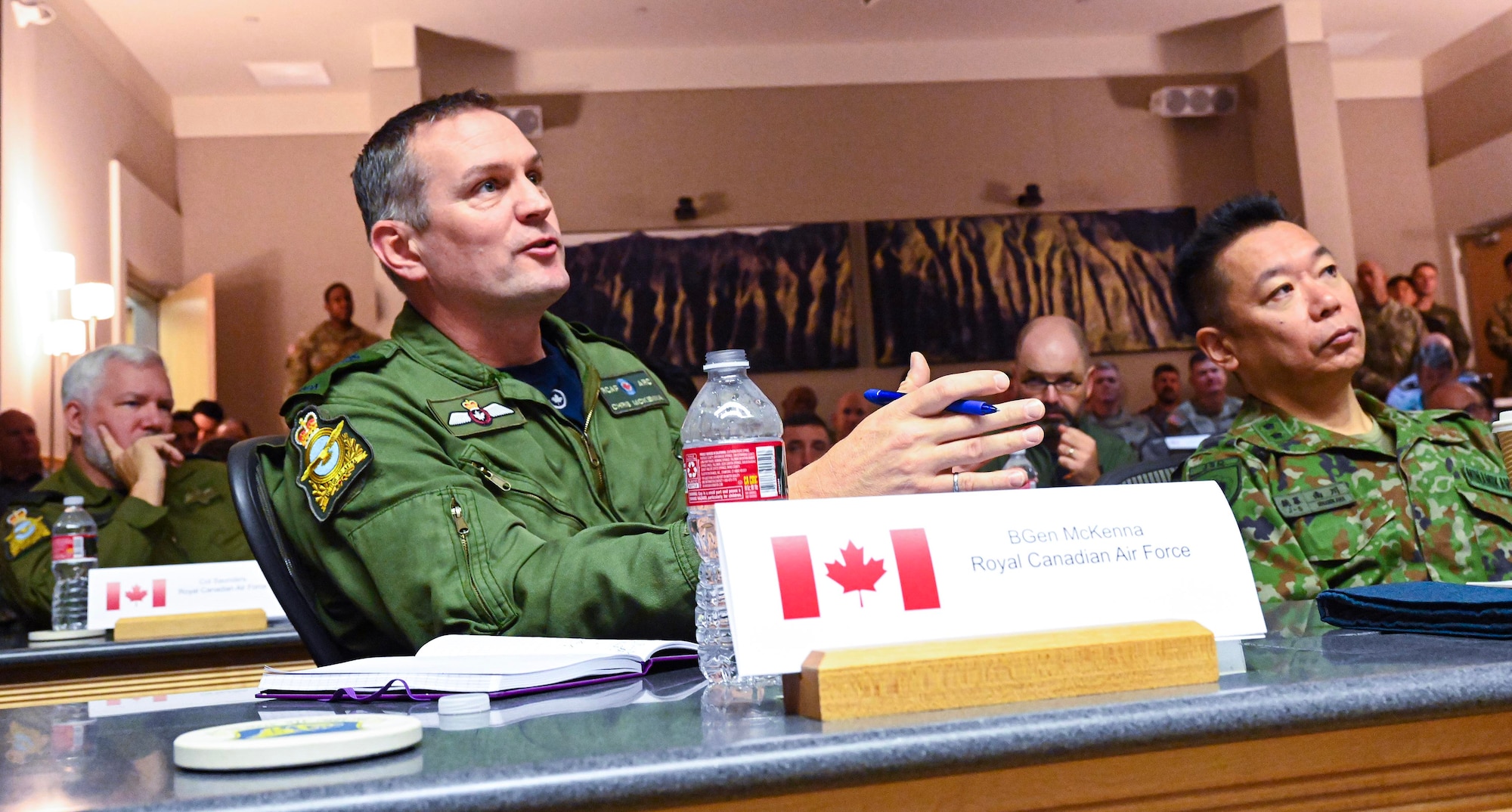 Royal Canadian Air Force Brig. Gen. Chris McKenna, Director General of Air and Space Force Development, speaks at the Multilateral Integrated Air and Missile Defense Summit at Joint Base Pearl Harbor-Hickam, Hawaii, Dec. 4, 2023. Throughout the annual meeting, representatives from seven countries participated in discussions concerning persistent regional challenges, interoperability and exploring opportunities to enhance air defense capabilities. (U.S. Air Force photo by Tech. Sgt. Nicholas Wilson)