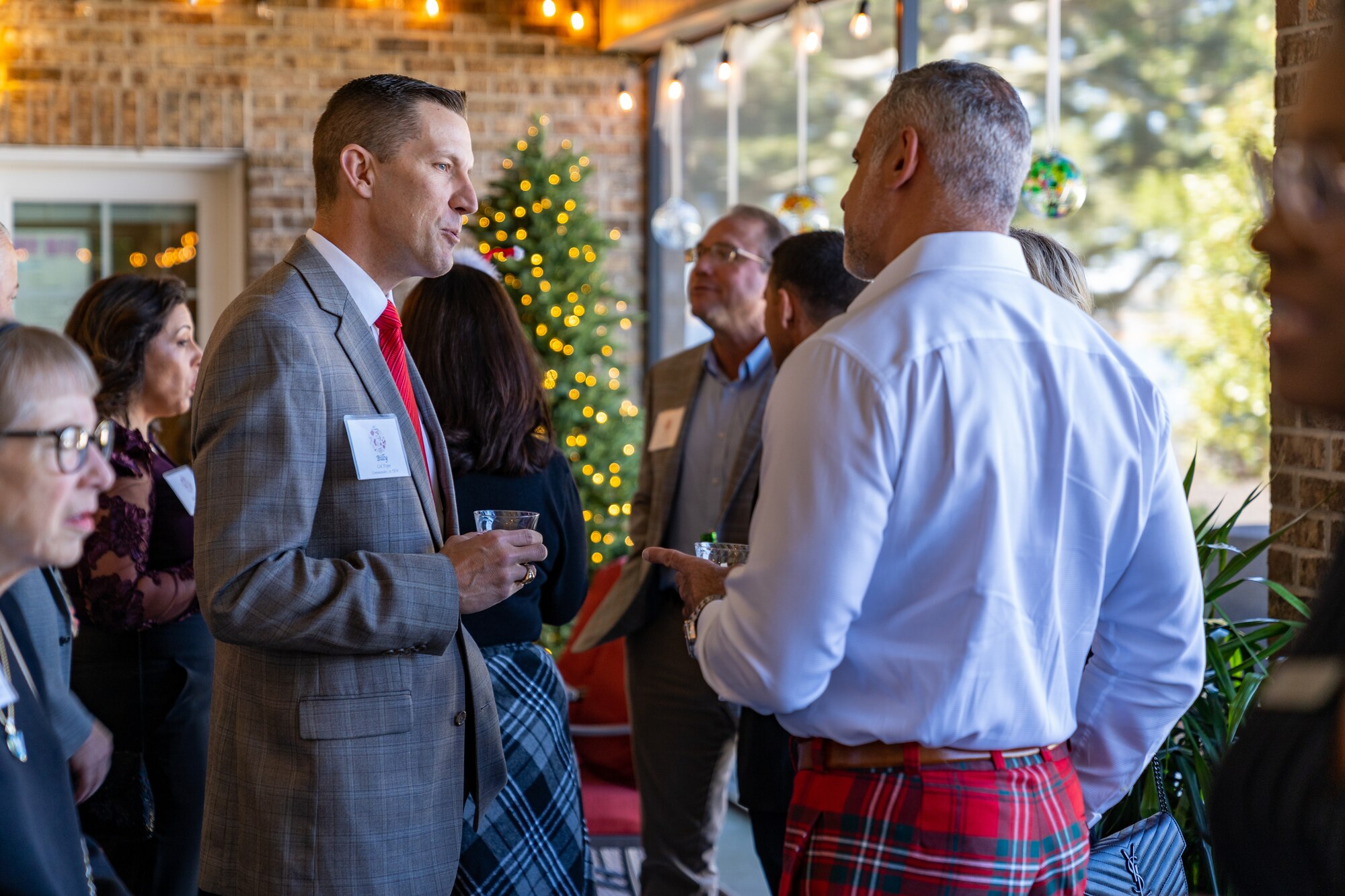 U.S. Air Force Col. Billy Pope Jr., 81st Training Wing commander, speaks with guests of the joint Holiday Social at Keesler Air Force Base, Mississippi, Dec. 17, 2023.