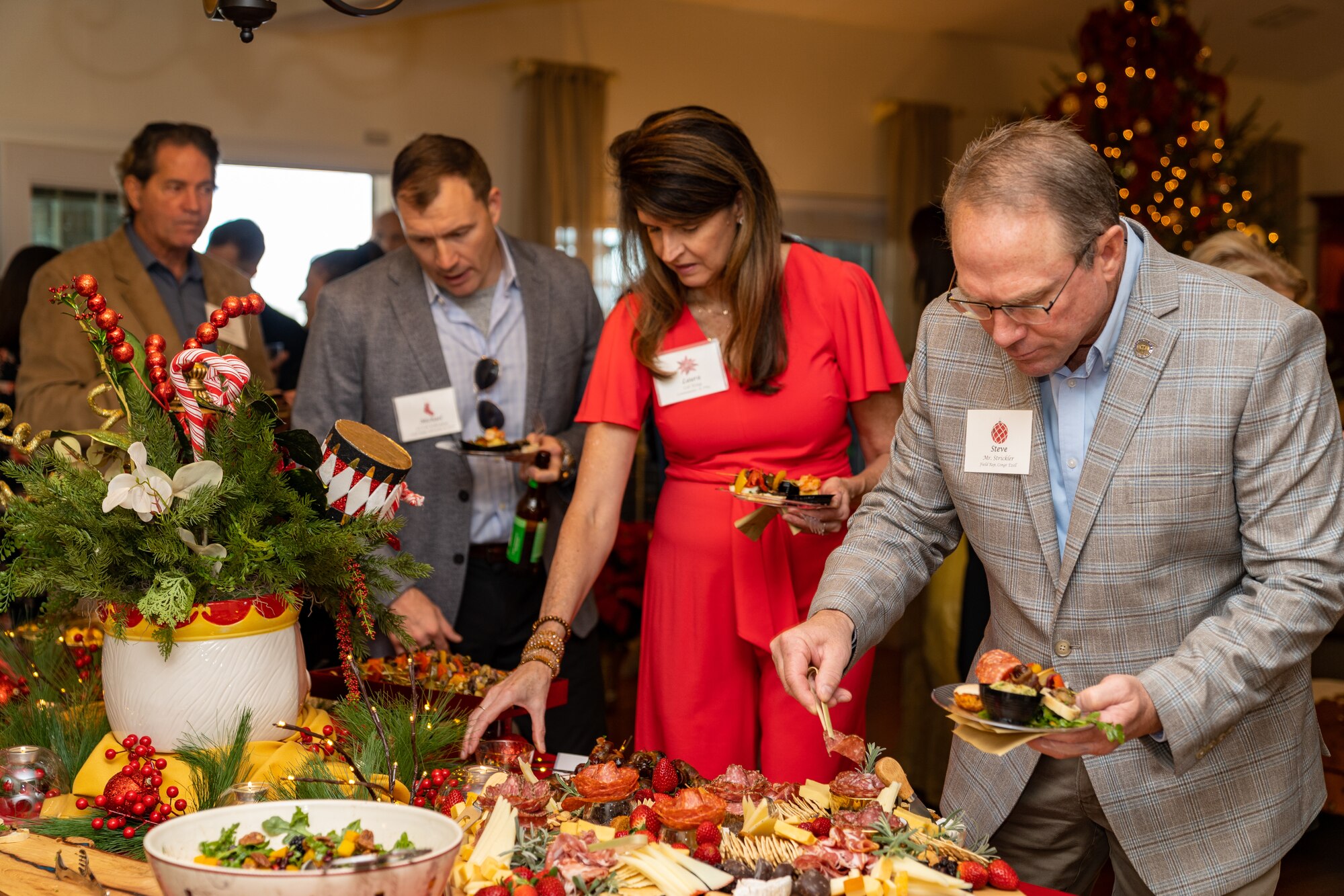 Guests of the joint Holiday Social serve themselves hors d’oeuvres during the joint Holiday Social at Keesler Air Force Base, Mississippi, Dec. 17, 2023.