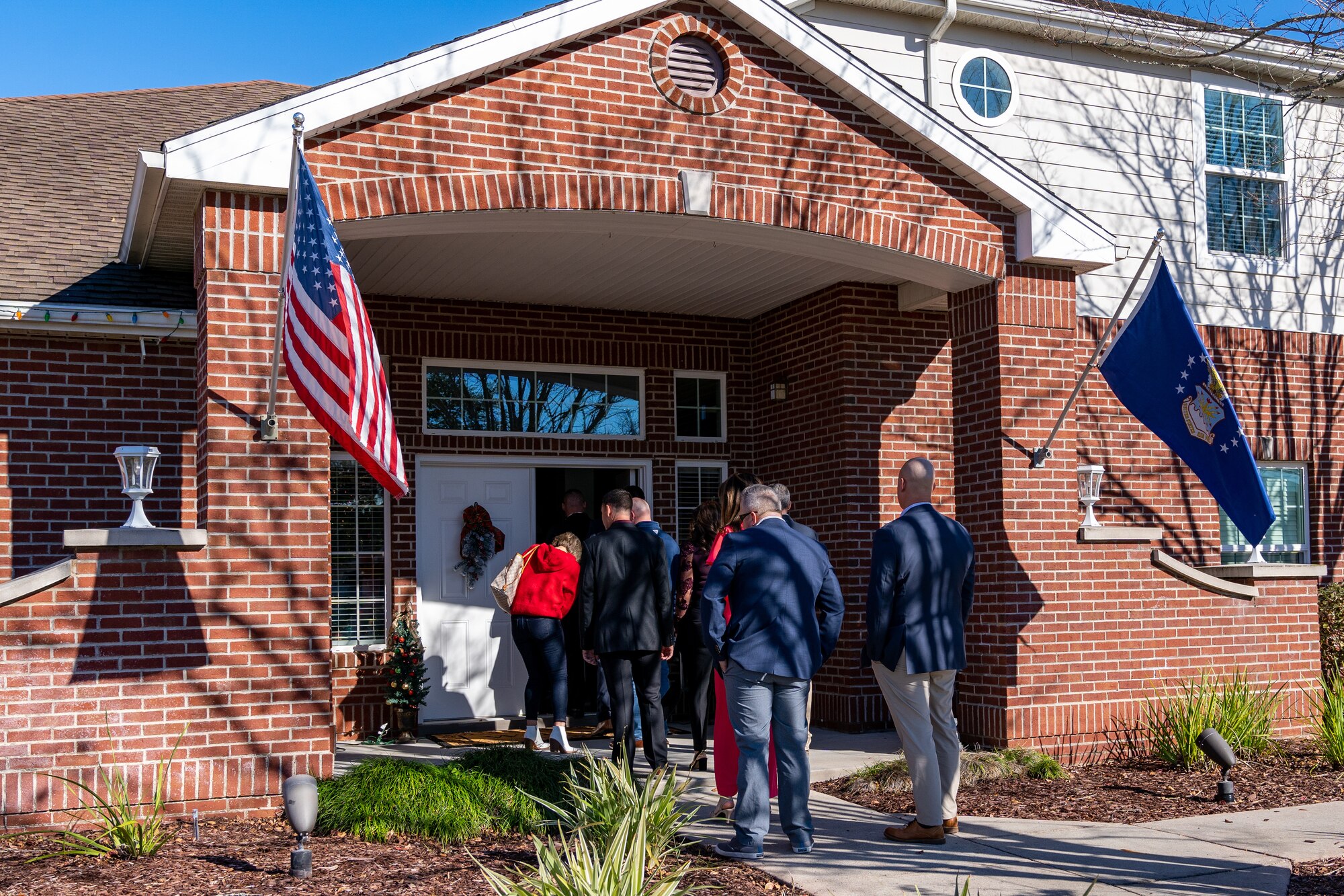 Guests line up at U.S. Air Force Col. Billy Pope Jr’s., 81st Training Wing commander, house during the joint Holiday Social at Keesler Air Force Base, Mississippi, Dec. 17, 2023.