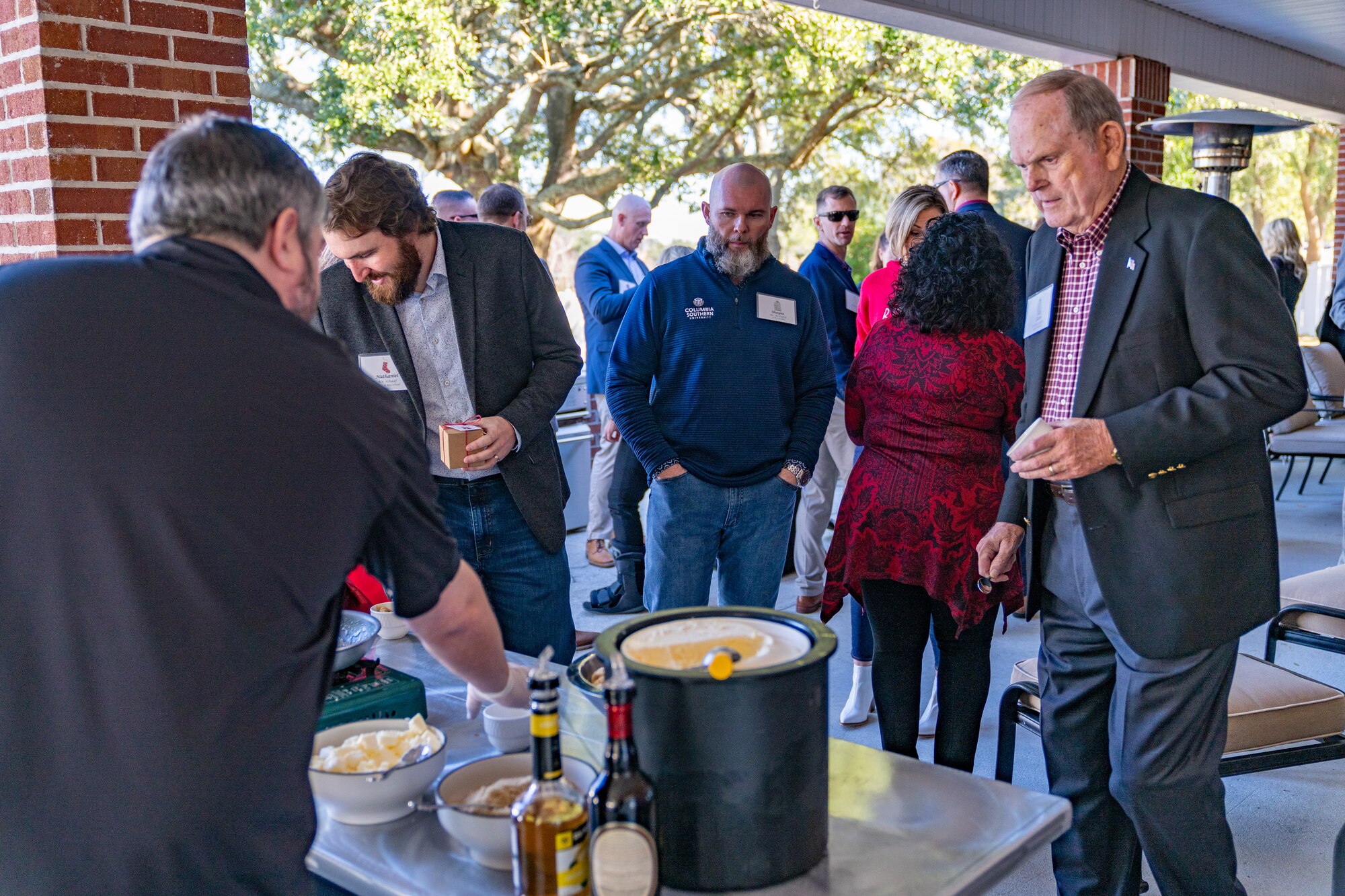 Guests of the joint Holiday Social wait line for bananas foster at Keesler Air Force Base, Mississippi, Dec. 17, 2023.
