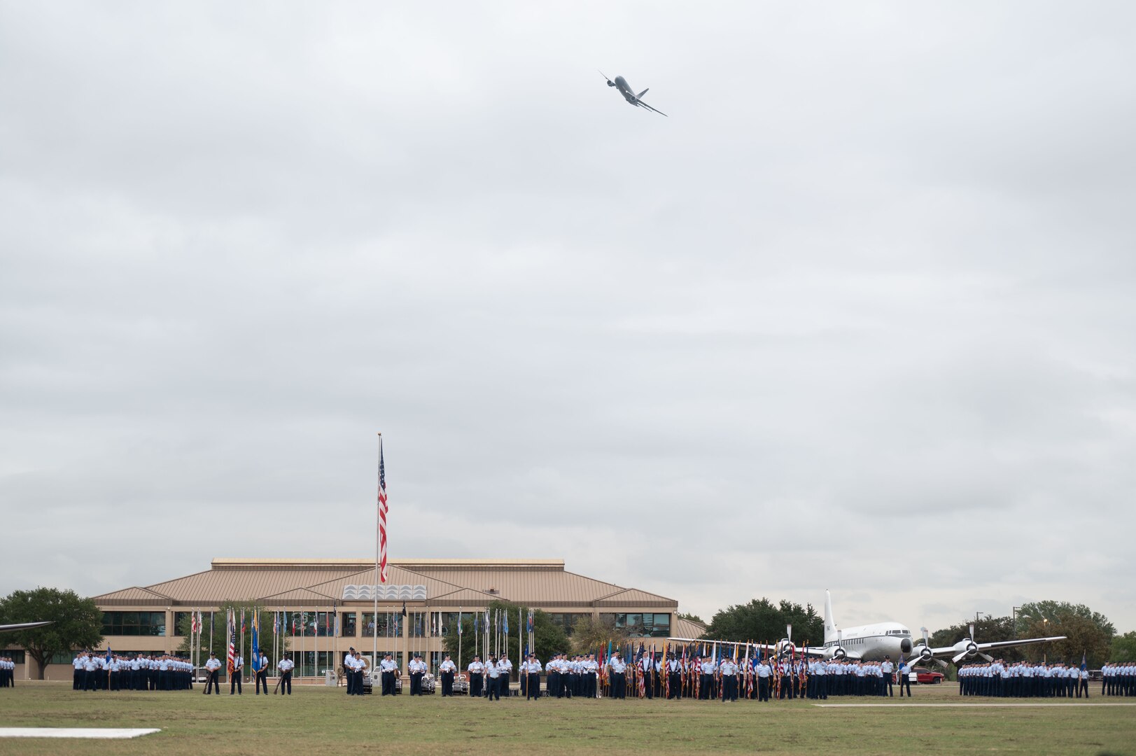 KC-46 Pegasus flies over BMT graduation parade.