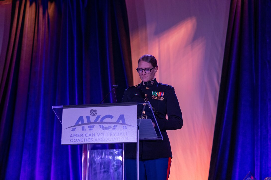 TAMPA, Fla.- U.S. Marine Corps Capt. Caroline Locksmith, a Marine Logistics Officer with Marine Forces Cyber at Fort Meade, Md., speaks to the coaches attending the American Volleyball Coaches Association Luncheon in Tampa, Fla., on Dec. 14, 2023, about the Marine Corps Partnership with the AVCA. The Marine Corps National Partnerships ensure the coaches of the next generation of Marines have the resources and skills to accurately present the Marine Corps as an option to their athletes, and support recruiter access to prospective audiences. (U.S. Marine Corps Photo by Lance Cpl. Payton Goodrich)