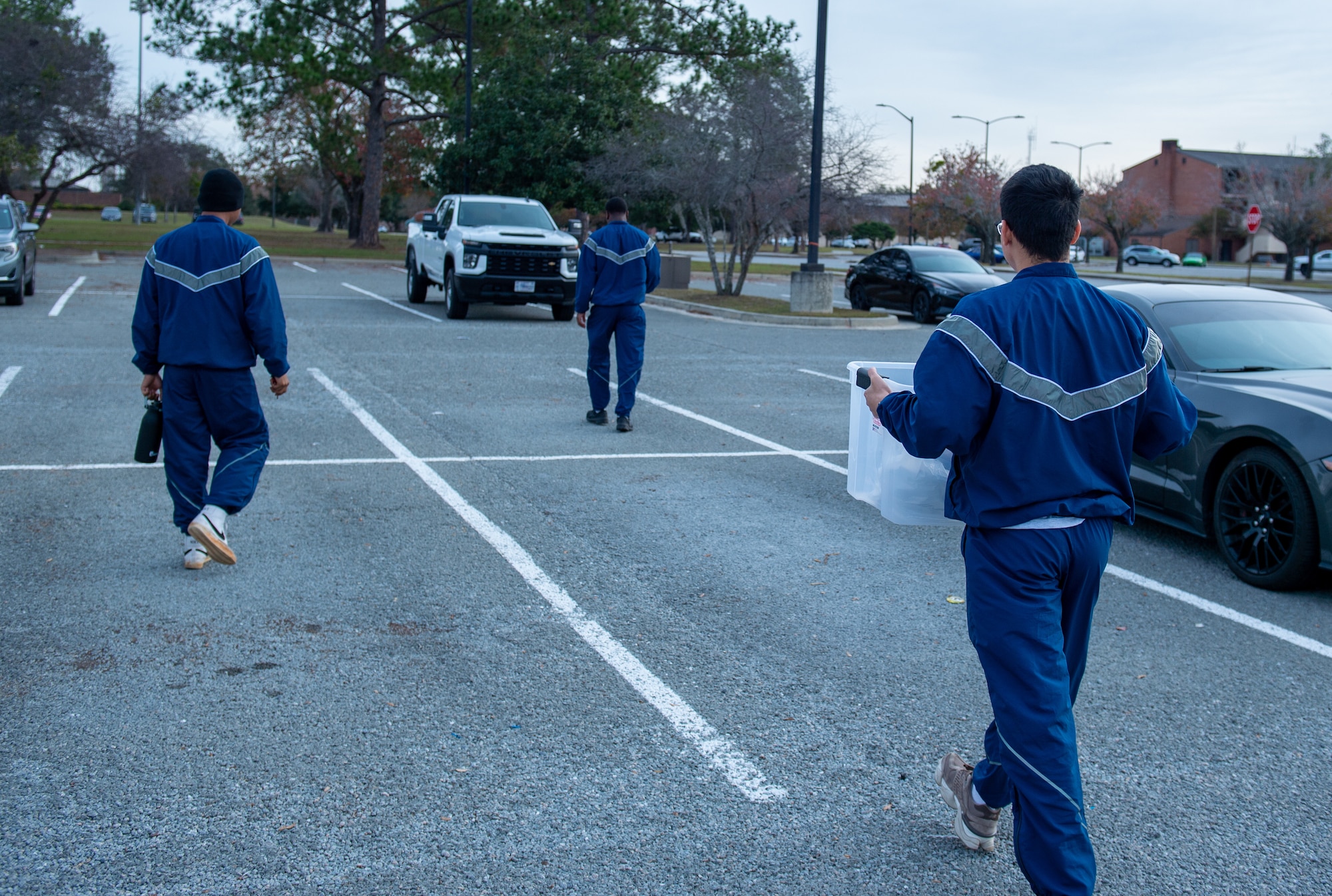 U.S. Air Force Airmen from Moody Air Force Base working for the Bay Orderly program, head out to start their workday, at Moody Air Force Base, Georgia, Dec. 14, 2023. As soon as the Airmen are given their task for the day, they grab the supplies they will need and head out to start working. (U.S. Air Force photo by Airman Cade Ellis)