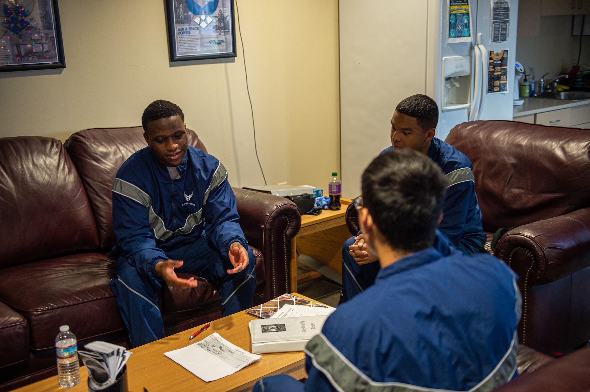 U.S. Air Force Airmen from Moody Air Force Base working for the Bay Orderly program, discuss their plan for the day at Moody Air Force Base, Georgia, Dec. 14, 2023. The Airmen assigned to Bay-O for the week start every day at the Dorm Management building where they receive their tasks for the day. (U.S. Air Force photo by Airman Cade Ellis)