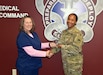 Michelle Laska, left, drug test coordinator for the Army Substance Abuse Program, or ASAP, at Fort Detrick and Forest Glen Annex, presents Staff Sgt. Chantele Kemp with the Fort Detrick UPL Challenge award for the first quarter of fiscal year 2022-23. The UPL, or unit prevention leader, serves as a liaison for each Army unit to ASAP's drug screening program. (C.J. Lovelace)