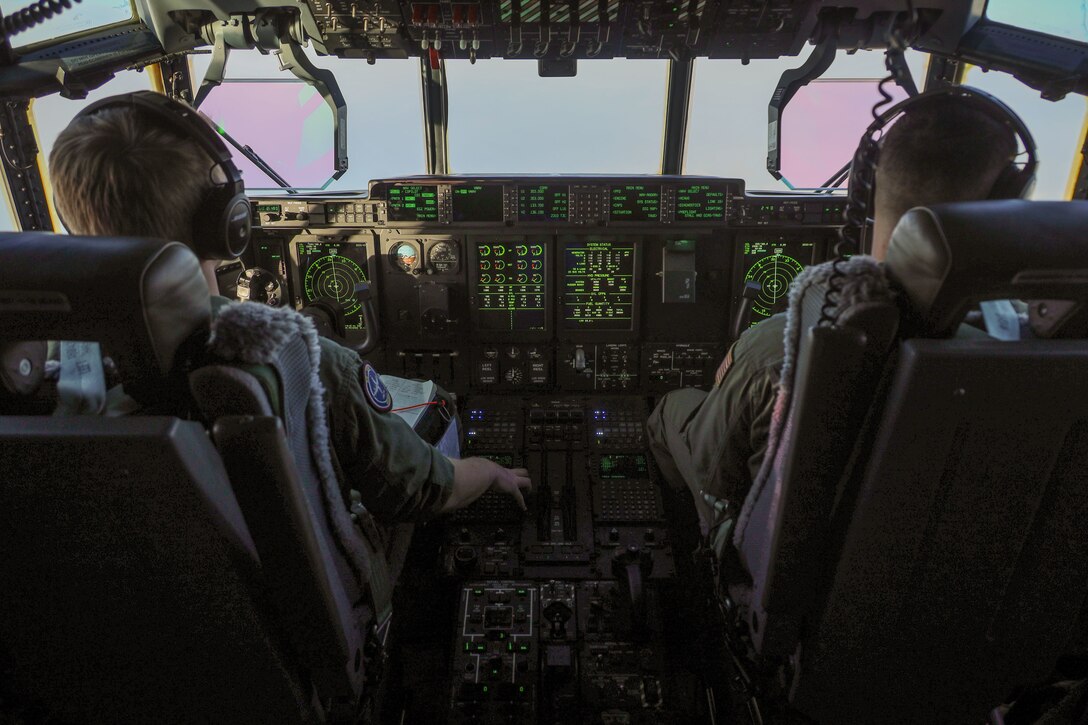 U.S. Marine Corps Maj. John Coutoumas, right, and Capt. Austin Davis, pilots with Marine Aerial Refueler Transport Squadron (VMGR) 153, Marine Aircraft Group 24, 1st Marine Aircraft Wing, operate a KC-130J Hercules in Anchorage, Alaska, Dec. 13, 2023. VMGR-153 conducted combat assault transport and air delivery in support of Alaska Marines’ Toys for Tots mission which enhanced combat readiness and supported community relations in remote Alaskan villages. (U.S. Marine Corps photo by Staff Sgt. Olivia Ortiz)