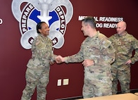 Col. Marc Welde, commander of U.S. Army Medical Logistics Command, congratulates Staff Sgt. Chantele Kemp after she received the Fort Detrick UPL Challenge award for the first quarter of fiscal year 2022-23. Also pictured is Capt. Matthew Lile, AMLC detachment commander. The UPL, which stands for unit prevention leader, serves as a liaison for each Army unit to the Army Substance Abuse Program, or ASAP. (C.J. Lovelace)