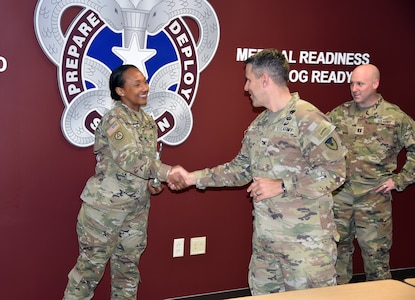 Col. Marc Welde, commander of U.S. Army Medical Logistics Command, congratulates Staff Sgt. Chantele Kemp after she received the Fort Detrick UPL Challenge award for the first quarter of fiscal year 2022-23. Also pictured is Capt. Matthew Lile, AMLC detachment commander. The UPL, which stands for unit prevention leader, serves as a liaison for each Army unit to the Army Substance Abuse Program, or ASAP. (C.J. Lovelace)