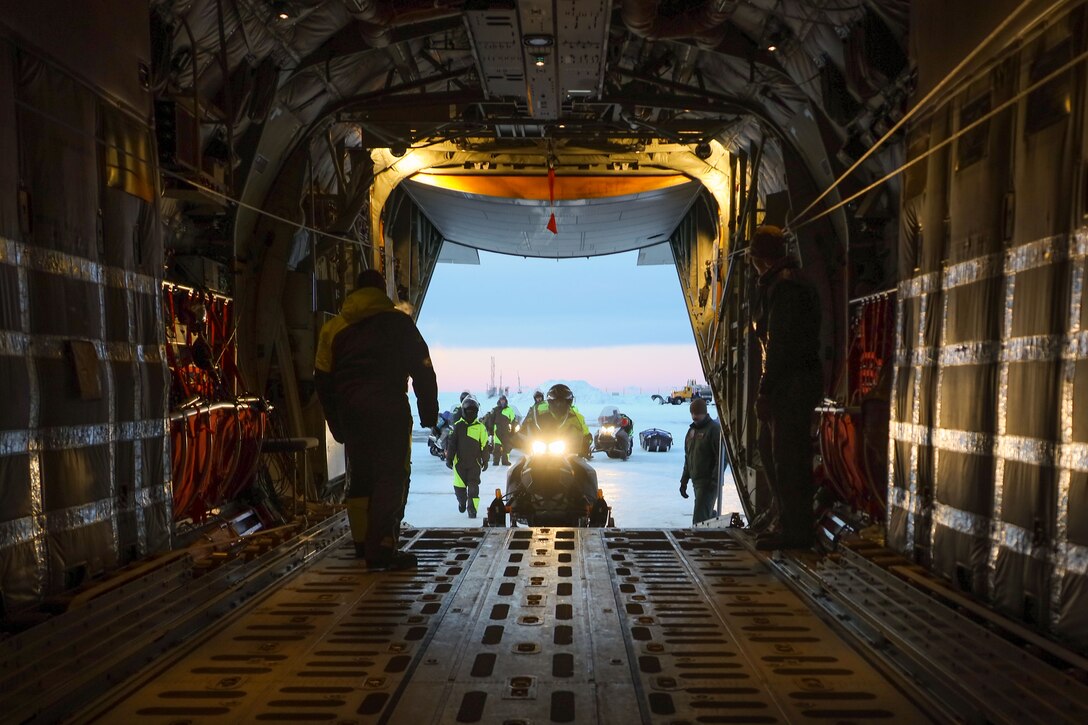 U.S. Marines with 4th Law Enforcement Battalion, Marine Forces Reserve, load snow machines onto a KC-130J Hercules assigned to Marine Aerial Refueler Transport Squadron (VMGR) 153, Marine Aircraft Group 24, 1st Marine Aircraft Wing to carry out the Toys for Tots mission in Kotzebue, Alaska, Dec. 13, 2023. VMGR-153 conducted combat assault transport and air delivery in support of Alaska Marines’ Toys for Tots mission which enhanced combat readiness and supported community relations in remote Alaskan villages. (U.S. Marine Corps photo by Staff Sgt. Olivia Ortiz)