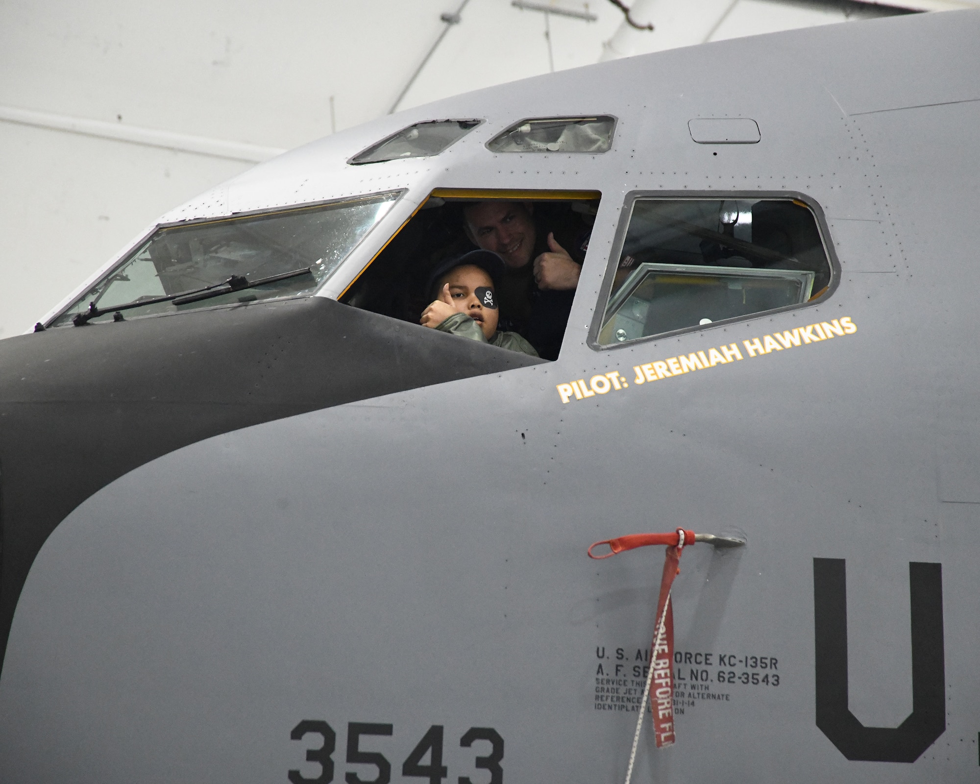 "Pilot for a Day," Jeremiah Hawkins, gives a thumbs up from the pilot seat while getting a tour of the Air Force's KC-135 Stratotanker aircraft. The stop at the 459th was part of a base tour arranged by a local non-profit foundation that organizes and funds "Pilot for a Day" events for children with serious medical conditions. (Air Force photo by Lt. Col. Timothy Smith)